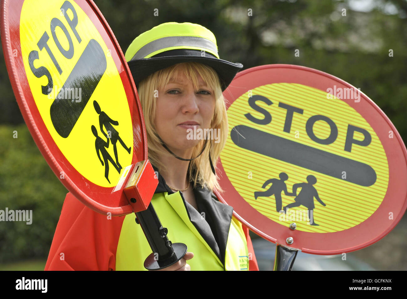 lollipop lady Helen Tilbury compares an old (right) and new hi-tech lollipop stick (left), which has CCTV video built-in to capture any motorists who break the law or become aggressive. Stock Photo