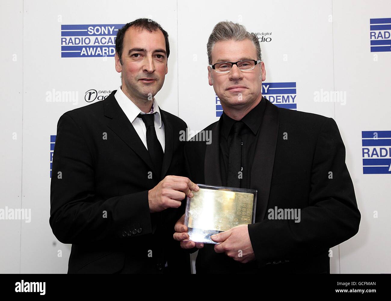 Mark Kermode (right) collects the Best Specialist Contributor award from Alistair McGowan at the Sony Radio Academy Awards 2010 at the Grosvenor House Hotel, London Stock Photo