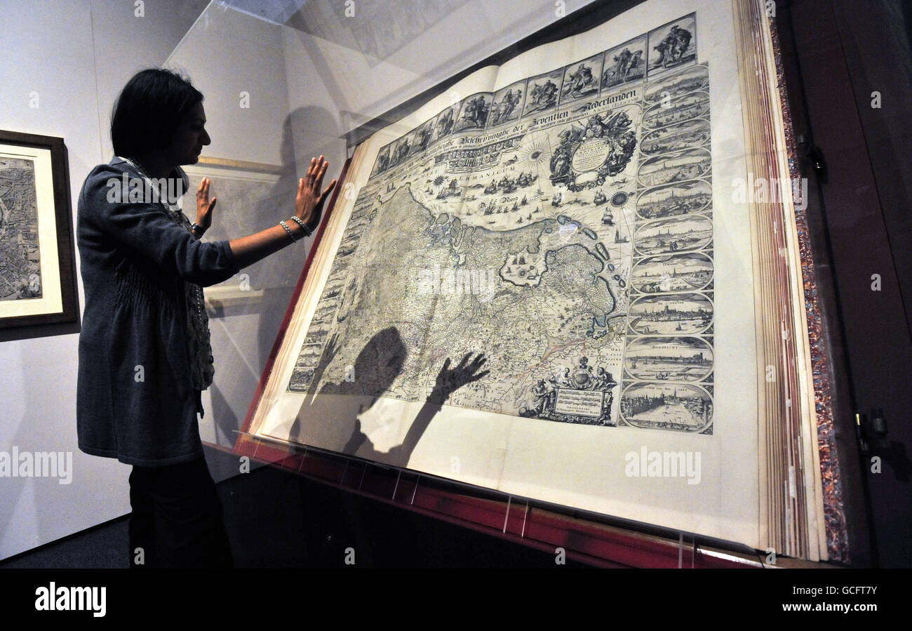 Staff member Radhika Dandeniya views the world's largest atlas which