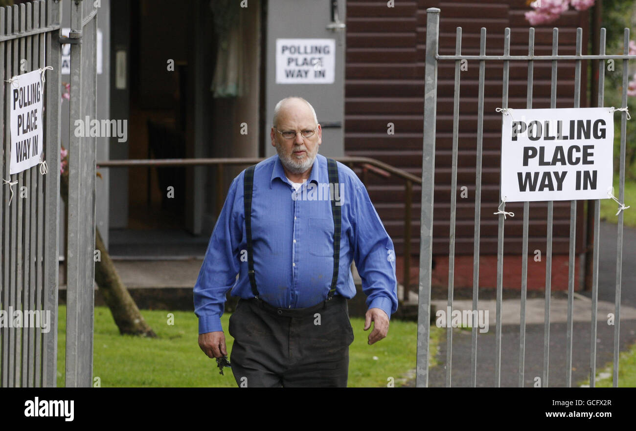 A member of the public leaves Broomhouse Community Hall polling station in Glasgow as voters across the UK prepared to elect a new government. Stock Photo