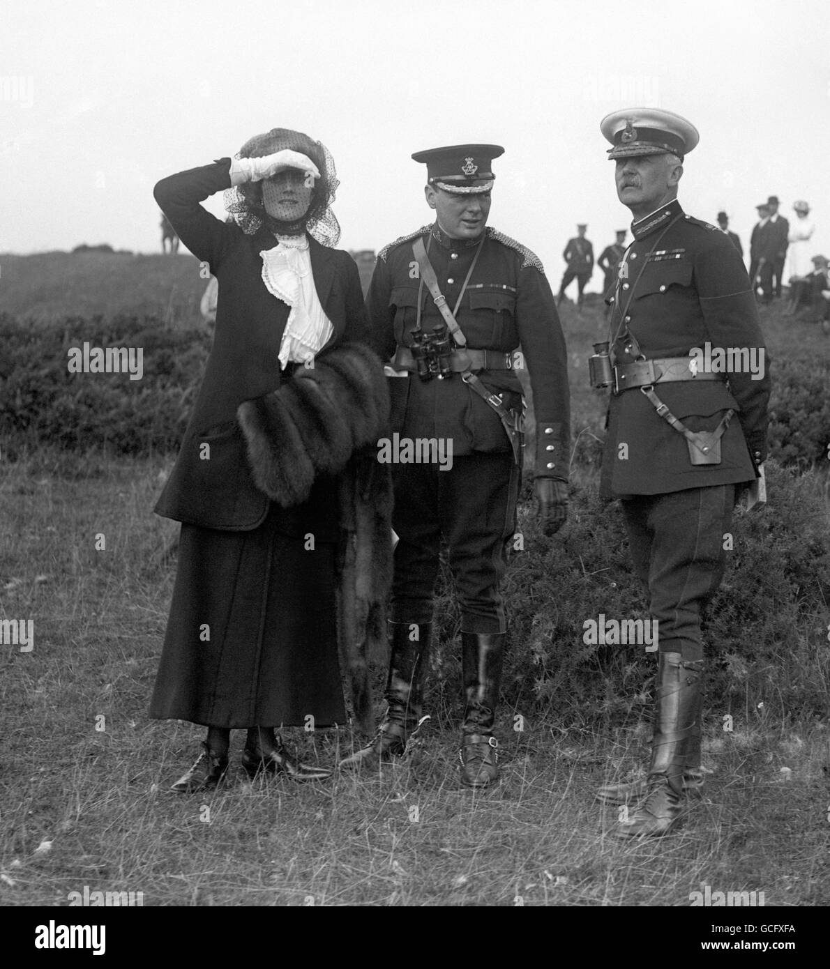 The Home Secretary Winston Churchill (centre) with his wife Clementine and General Bruce Hamilton watching Army maneuvers at Aldershot. Stock Photo