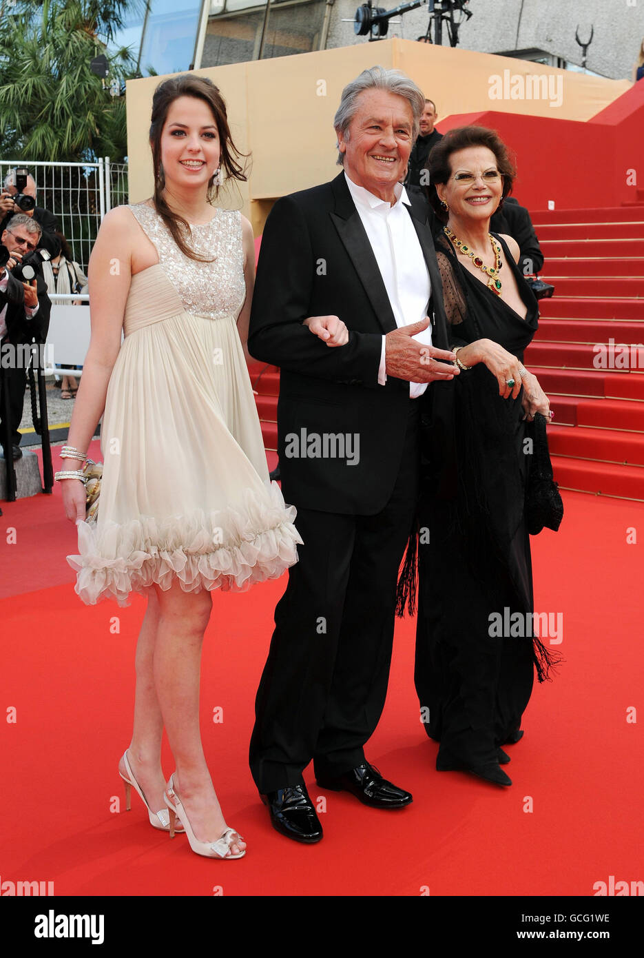 Alain Delon and Claudi Cardinale, right, and Anouska Delon arrive for the screening of Wall Street: Money Never Sleeps at the Grand Auditorium Lumiere during the Cannes Film Festival, France. Stock Photo