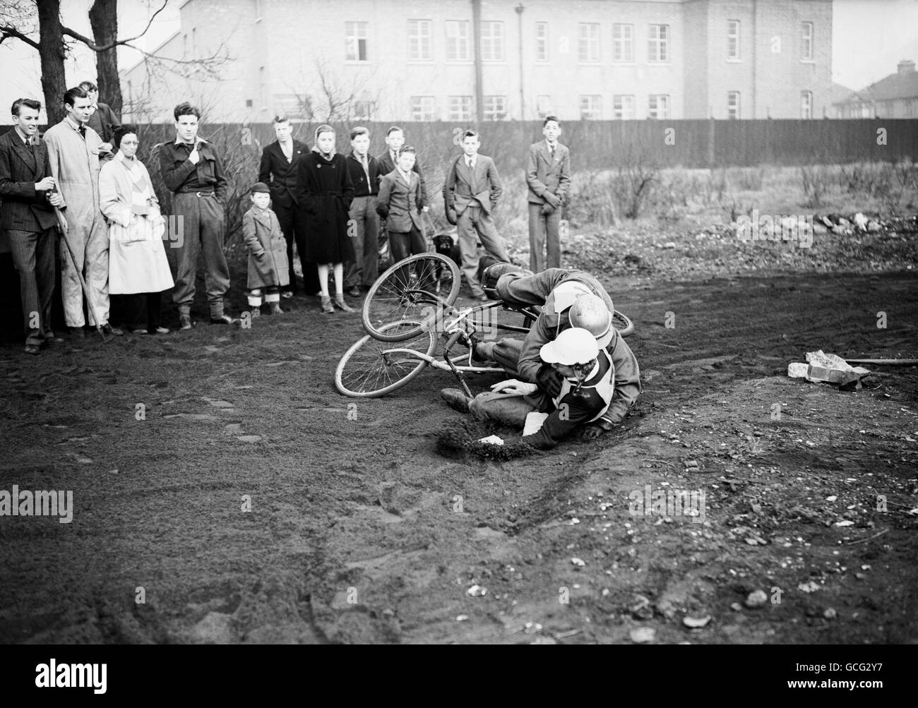 The latest sport to capture the younger generation - The International teams race in their own hometowns and the carefully timed results are sent to the cycle speedway control board for the declaration of the winner. Here Roy Rogers and Don Mahoney (aged 15) come to grief while cornering Stock Photo