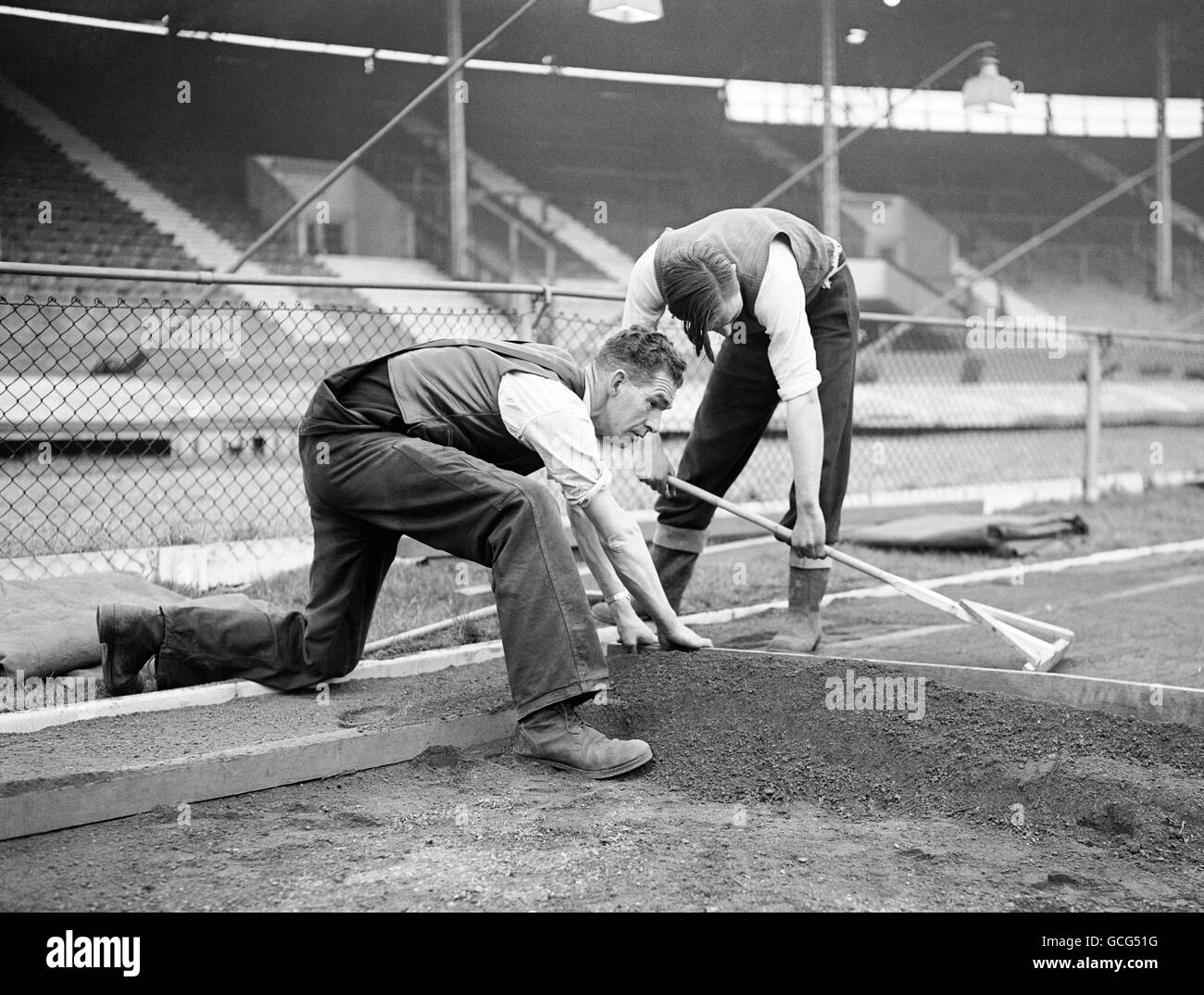 Relaying the White City Running Track 1949. The thickness of the top dressing is shown is this picture as the levelling process is carried out Stock Photo