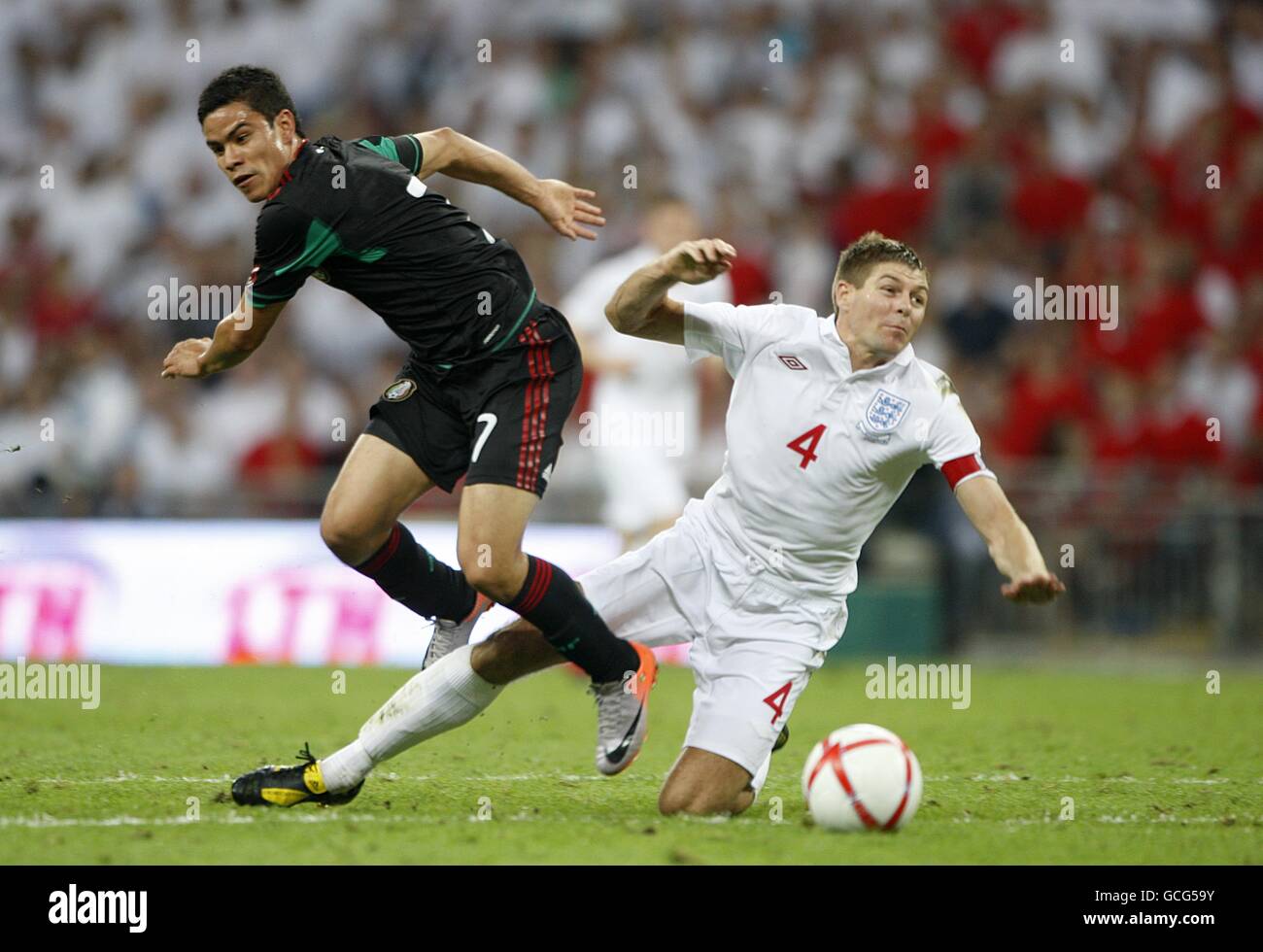 Soccer - International Friendly - England v Mexico - Wembley Stadium. England's Steven Gerrard (right) and Mexico's Pablo Barrera battle for the ball Stock Photo