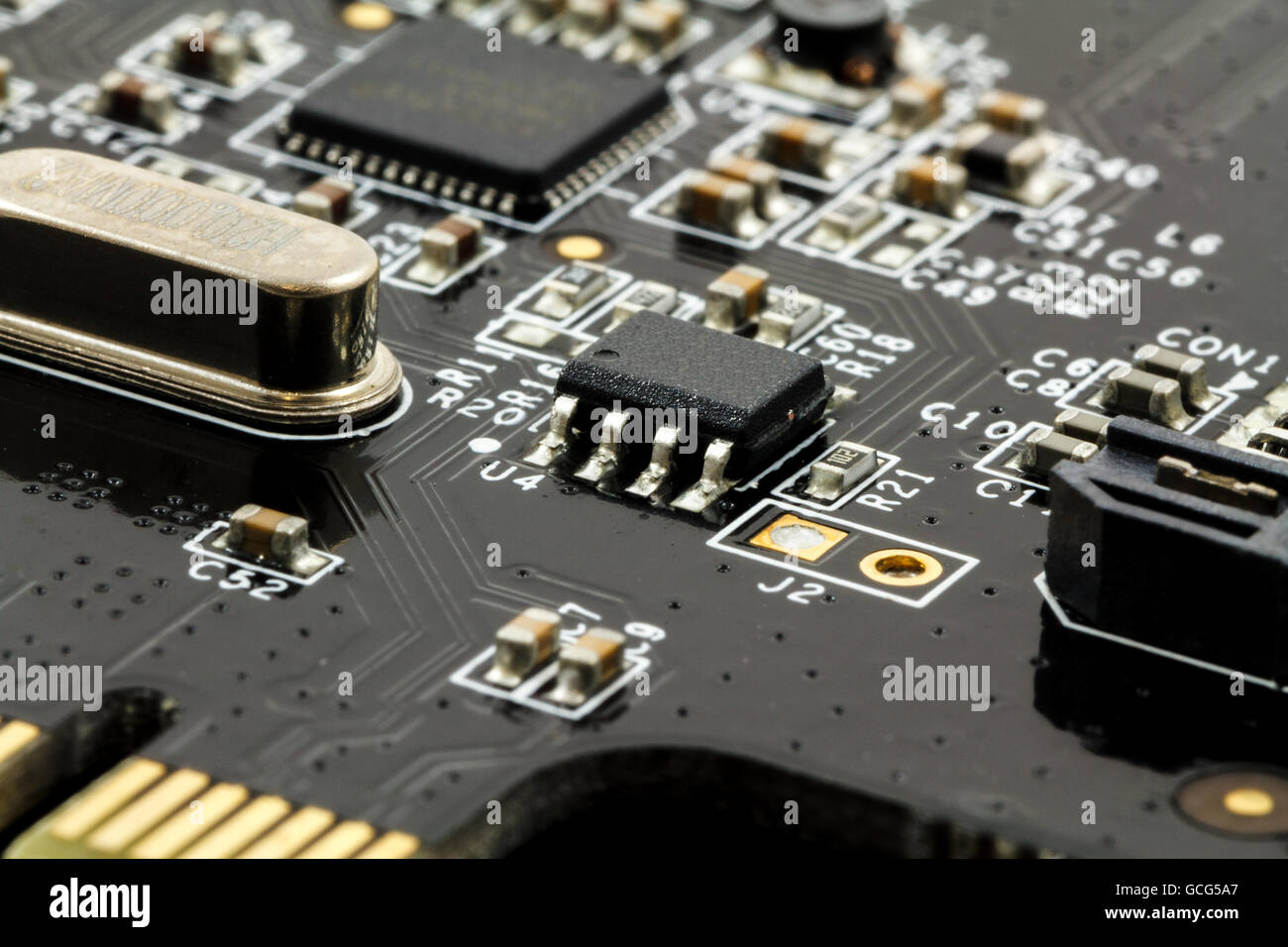 Printed Circuit Board (PCB) with, ICs, Capacitors, and Resistors Stock Photo
