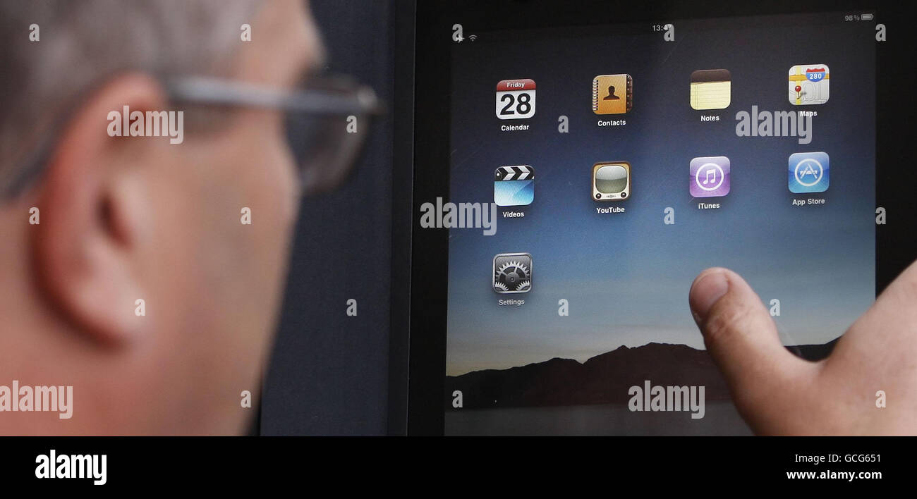 A man uses his new iPad outside the Apple store in Glasgow Stock Photo ...