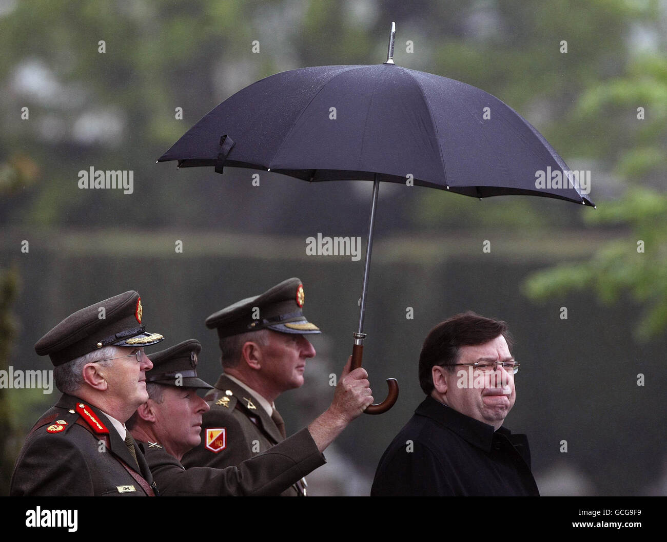 Taoiseach Brian Cowen is sheltered from the rain at the annual 1916 Commemoration Ceremony at Arbour Hill Church in Dublin. Stock Photo