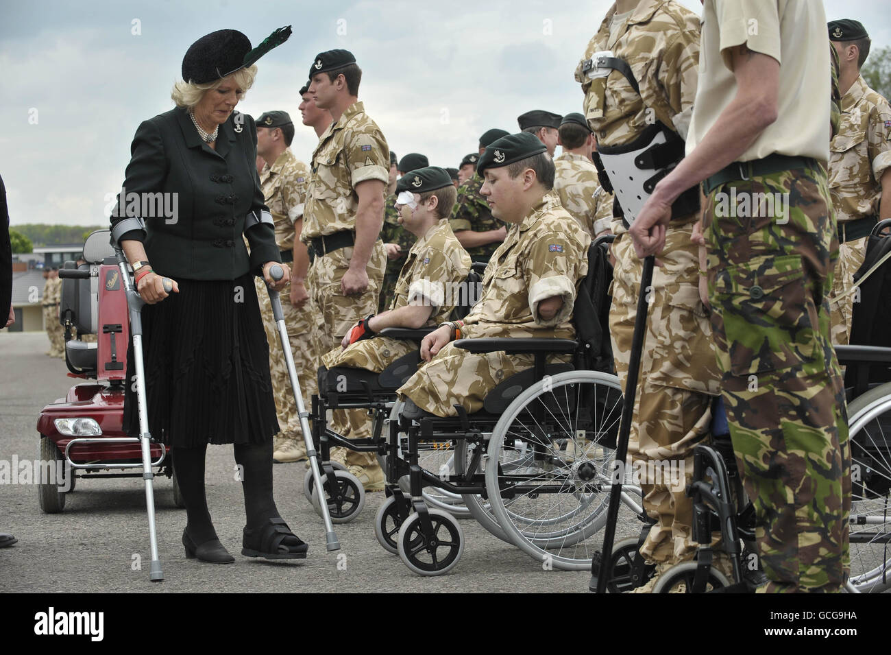 The Duchess of Cornwall stands on crutches to greet injured soldiers at Bulford Camp, Wiltshire, where she presented Afghanistan campaign medals to soldiers of 4th Battalion The Rifles. Stock Photo