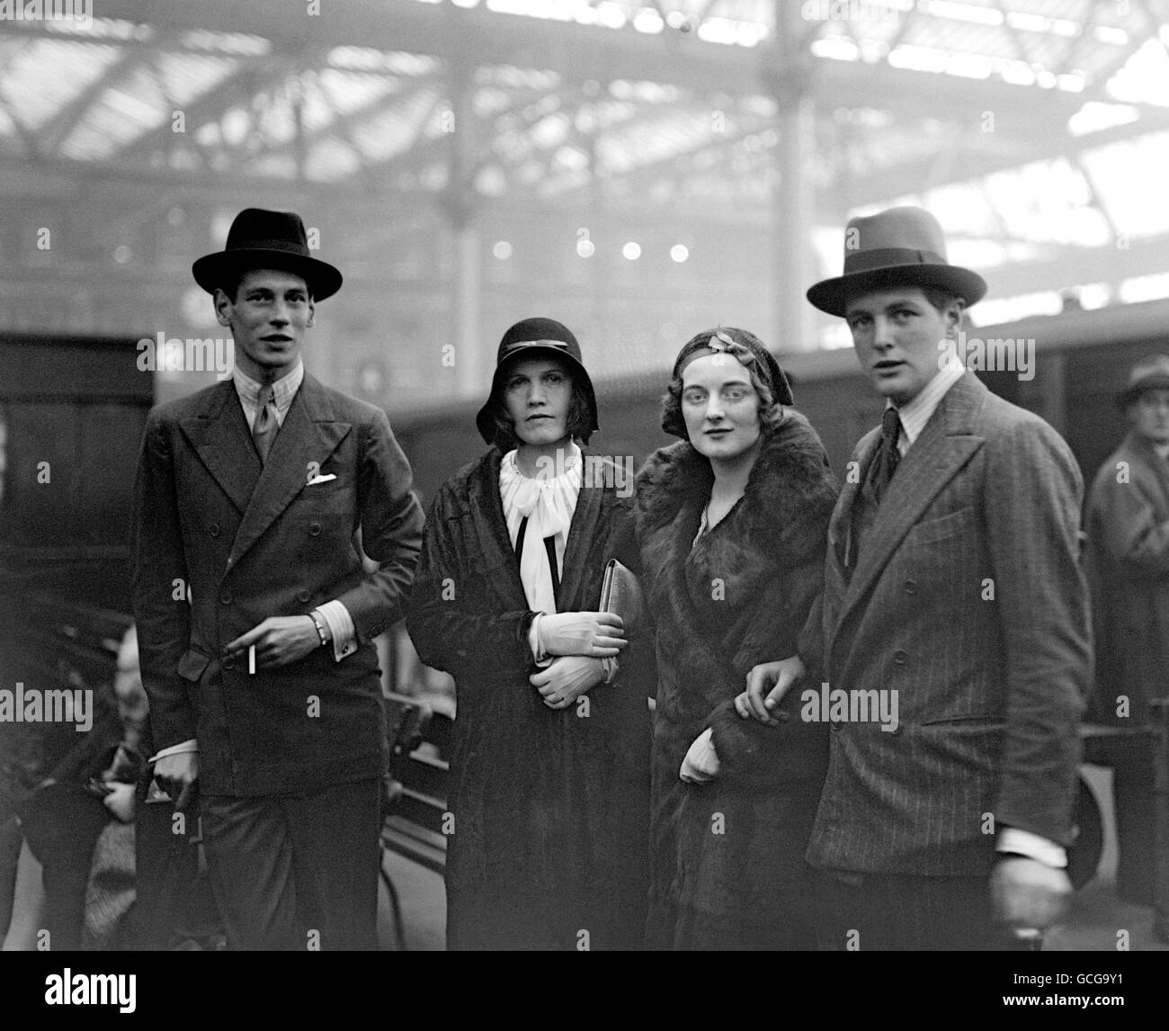 Randolph Churchill, the son of Winston Churchill, right, holding the arm of his sister Diana Churchill, at Waterloo Station before leaving for America. Stock Photo