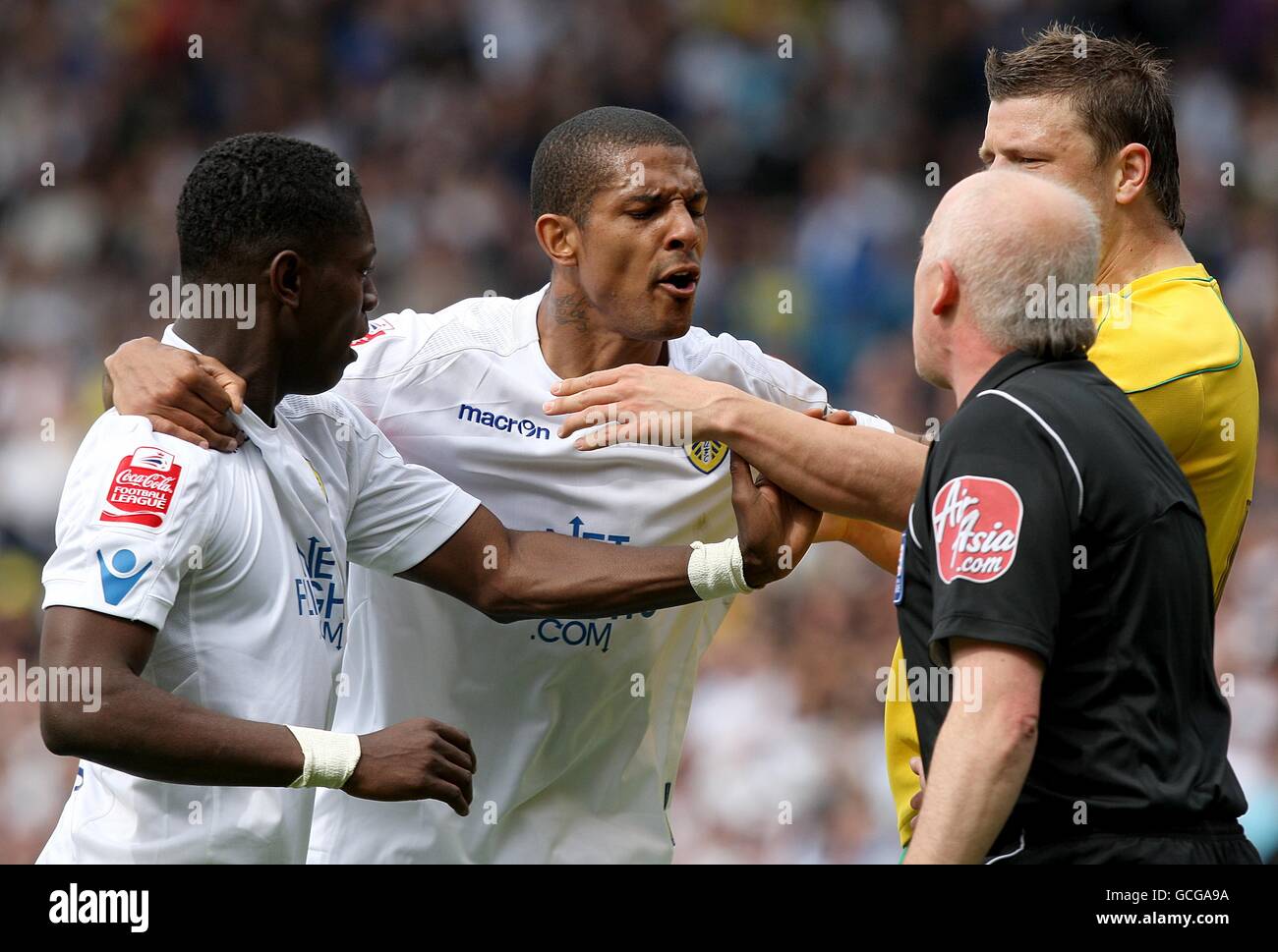 Leeds United's Max Gradel (left) is held back by team mate Jermaine Beckford after being shown a red card by referee Graham Salisbury Stock Photo