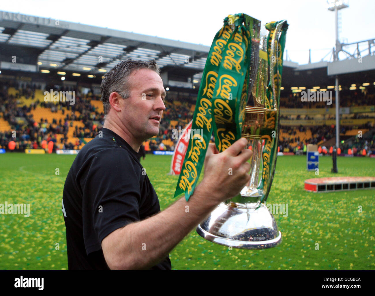 Norwich City's Manager Paul Lambert savours the moment with the trophy Stock Photo