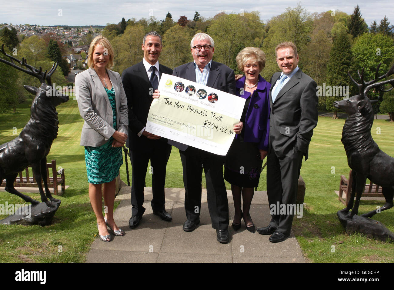 Actor Christopher Biggins(centre) with (left to right) Ann Maxwell, founder of the Muir Maxwell Trust, Andreas Panayiotou of Ability Group, Dame Maureen Thomas and Simon Vincent, area president Europe for Hilton Worldwide, as the actor presents Ann Maxwell founder of the Muir Maxwell Trust with a cheque for over 200,000 towards charity funding on behalf of the Hilton, at Doubletree by Hilton Dunblane Hydro Hotel. Stock Photo