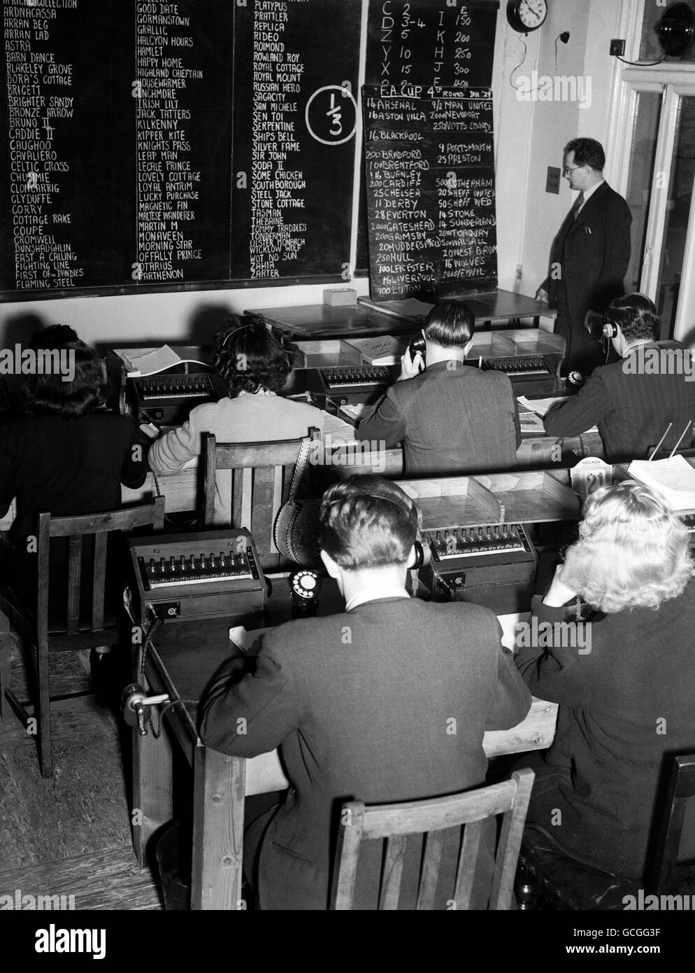 The Business of a modern large book maker 1949. In the ante post betting room where bets are placed for future races and the FA Cup Final Stock Photo