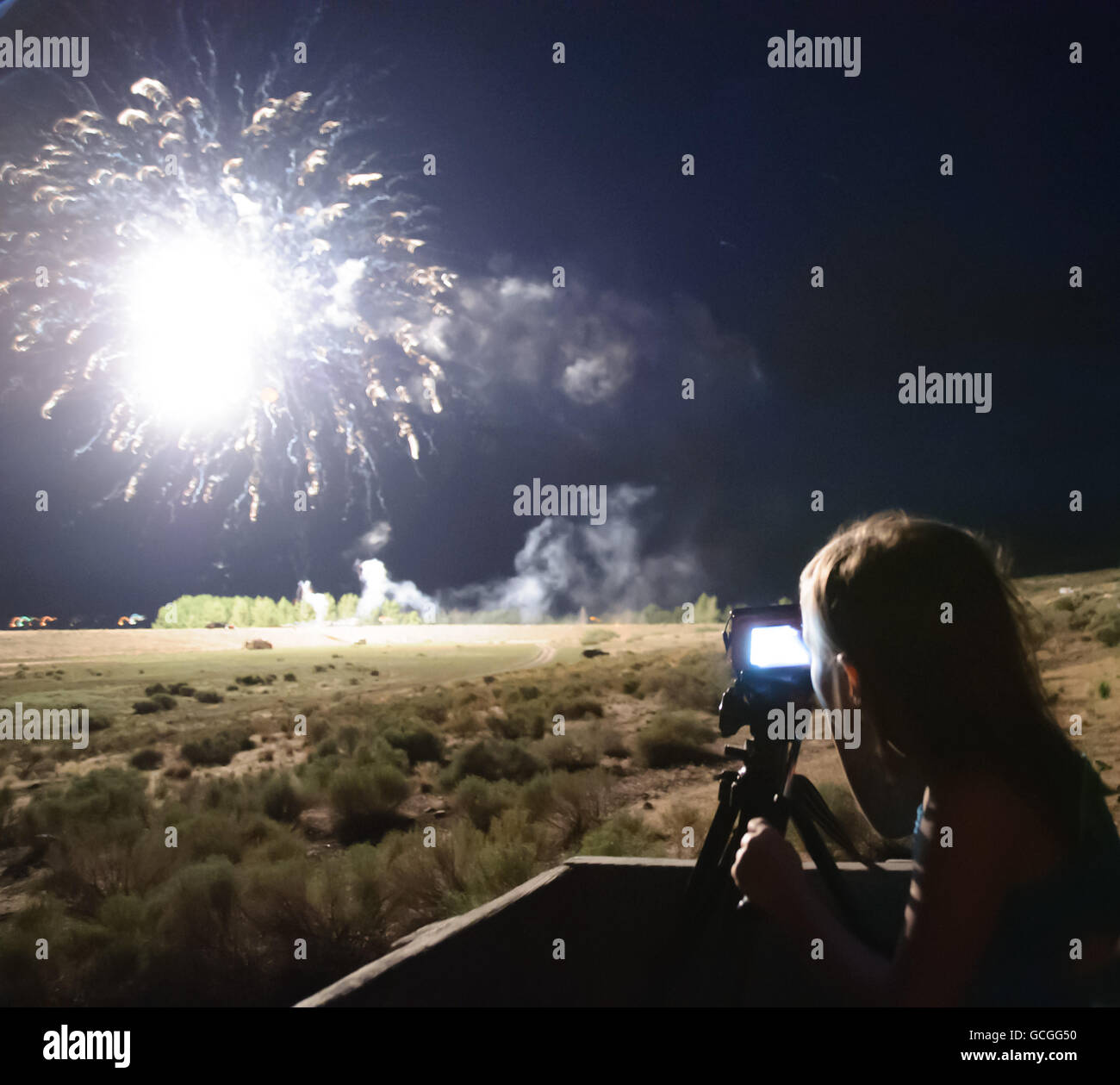 Girl photographing fireworks Stock Photo Alamy
