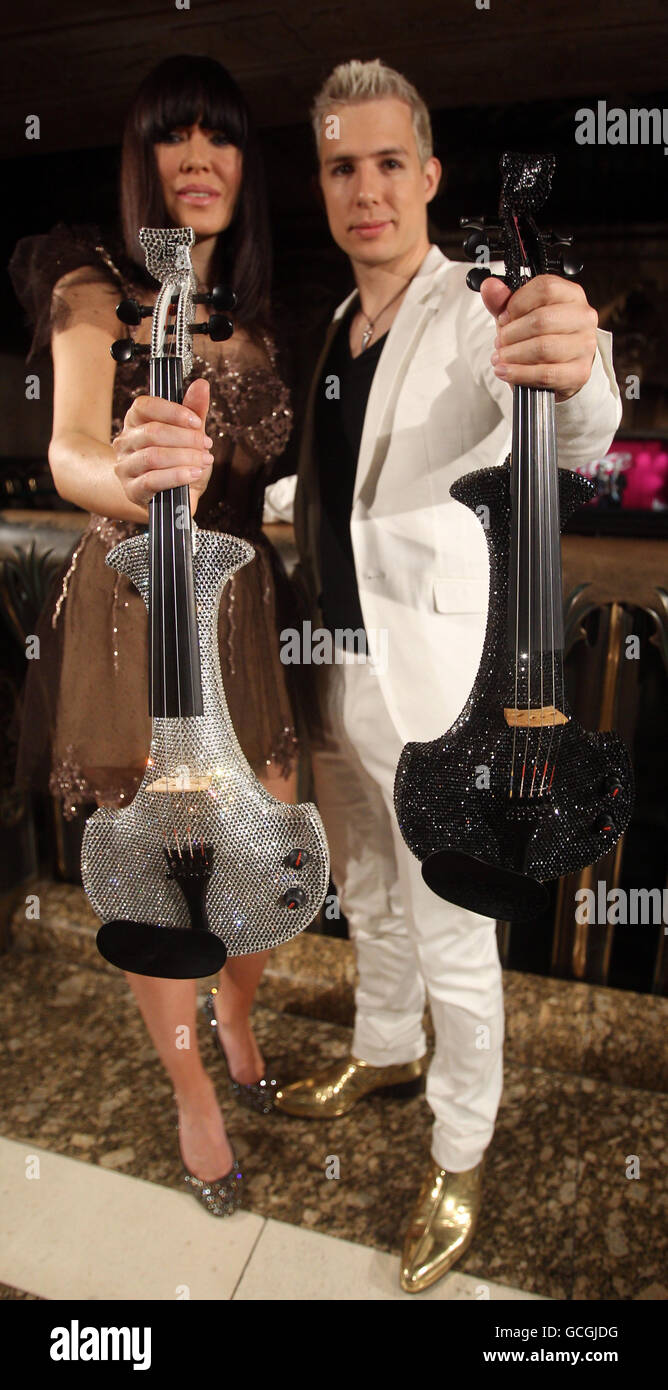 left to right) Rock electric violin Fuse, Linzi Stoppard and Ben Lee show new one million pound Swarovski encrusted violins in Harrods, Stock Photo - Alamy