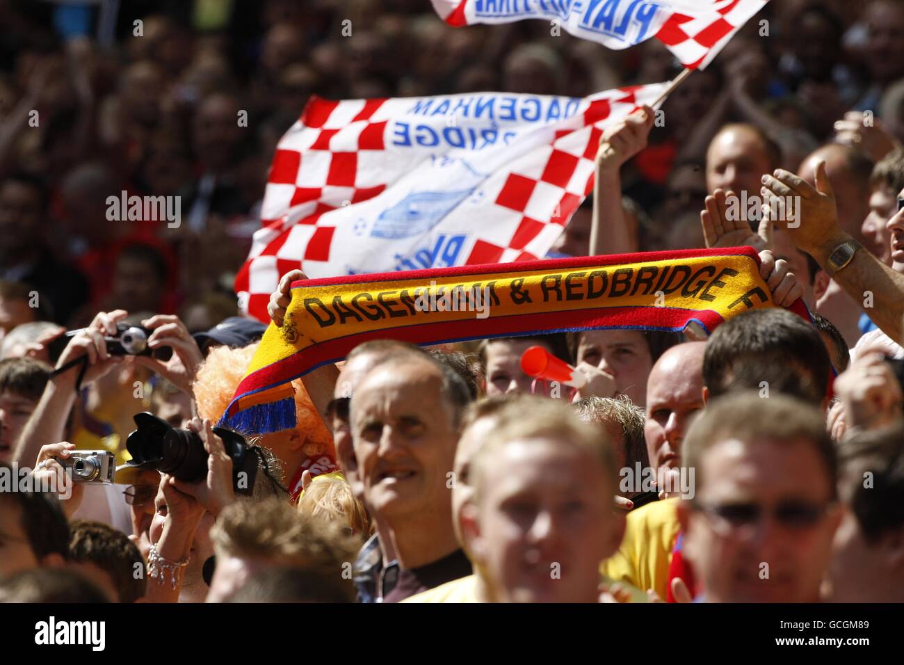 Dagenham and Redbridge fans cheer on their side in the stands Stock