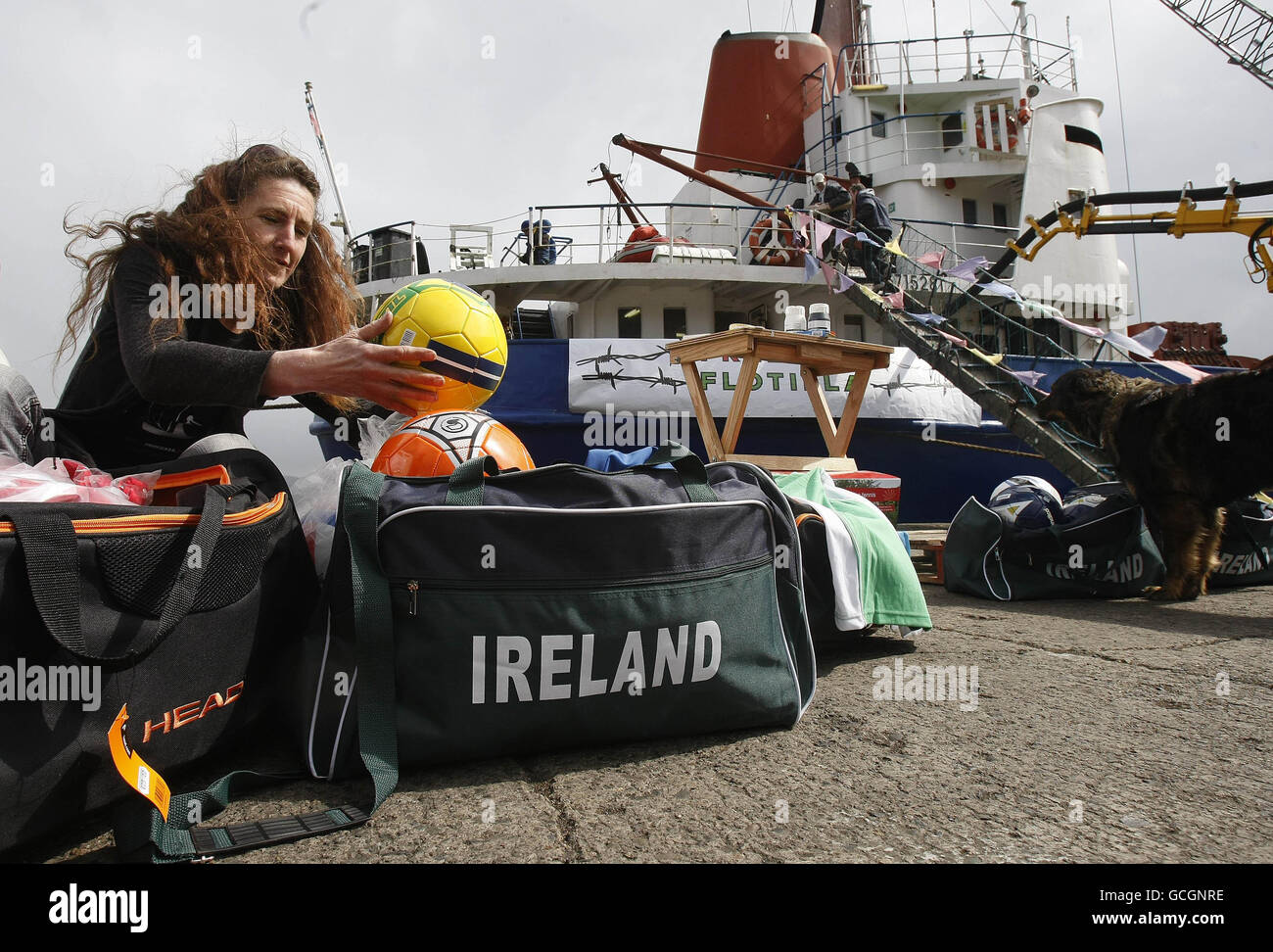 Activist Naimh Moloughney packs bags to be loaded into the Cargo ship the MV Rachel Corrie named after a after a human rights activist killed by the Israeli military, before departing from Dundalk Harbour for the Middle East with a cargo of cement and supplies for Gaza. Stock Photo