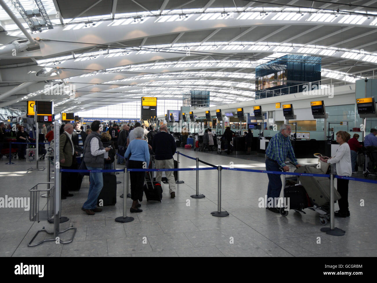 Passengers wait at Heathrow Airport after volcanic ash caused delays and cancellations across the UK. Stock Photo