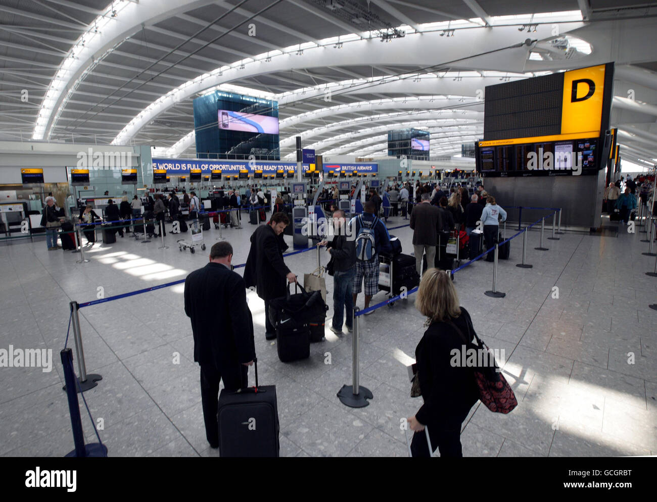 Passengers wait at Heathrow Airport after volcanic ash caused delays and cancellations across the UK. Stock Photo