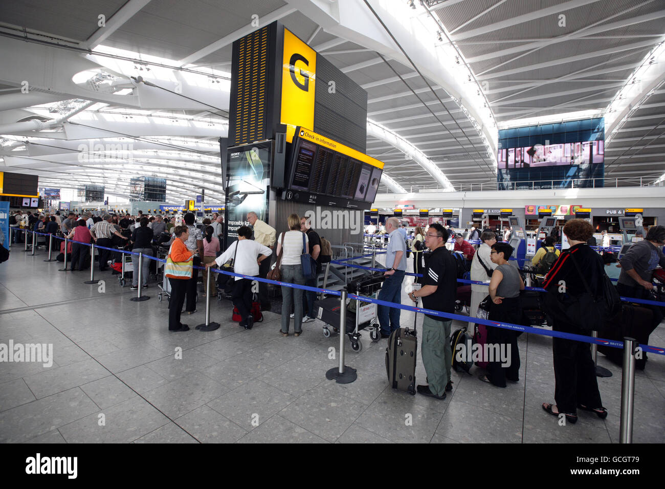 Passengers queue in Terminal 5 of Heathrow Airport after volcanic ash