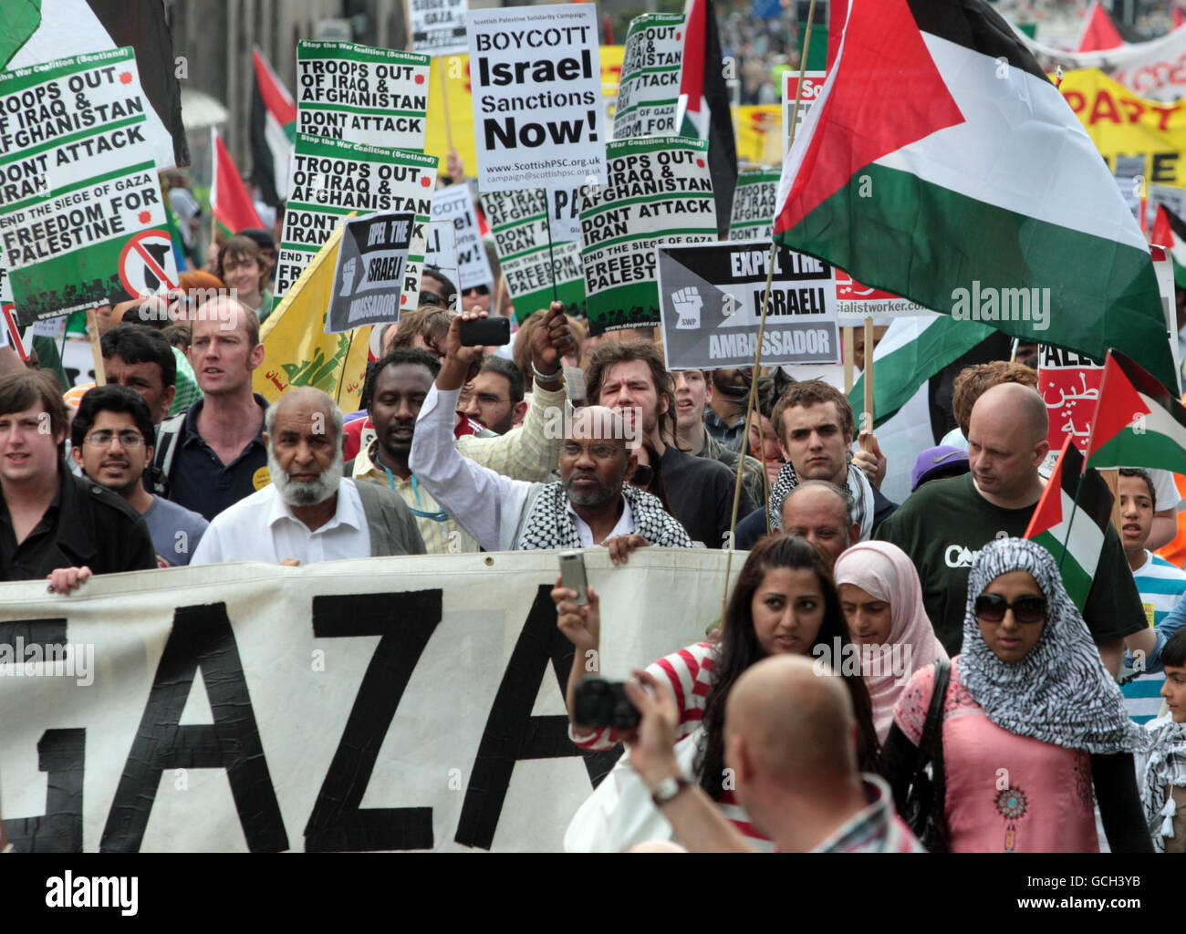 A boycott Israel protest parades through the centre of Edinburgh protesting at the death of nine people killed by Israeli commandos on a ship in a flotilla of aid boats bound for Gaza. Stock Photo