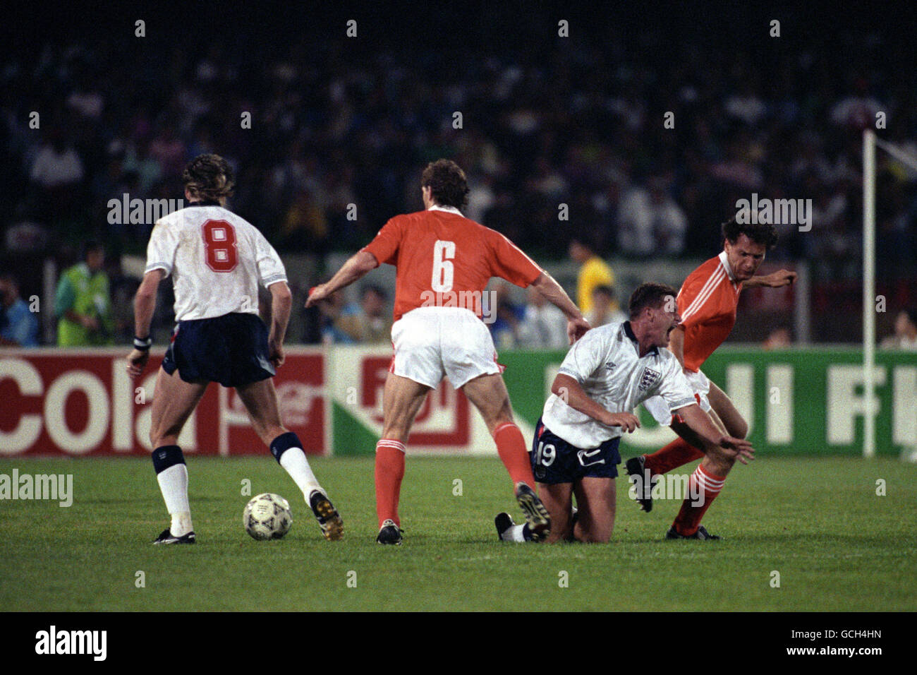 England's Paul Gascoigne is tackled by Netherlands' Hans GILLHAUS (r) and Jan WOUTERS (6) watched by England's Chris Waddle (8) Stock Photo