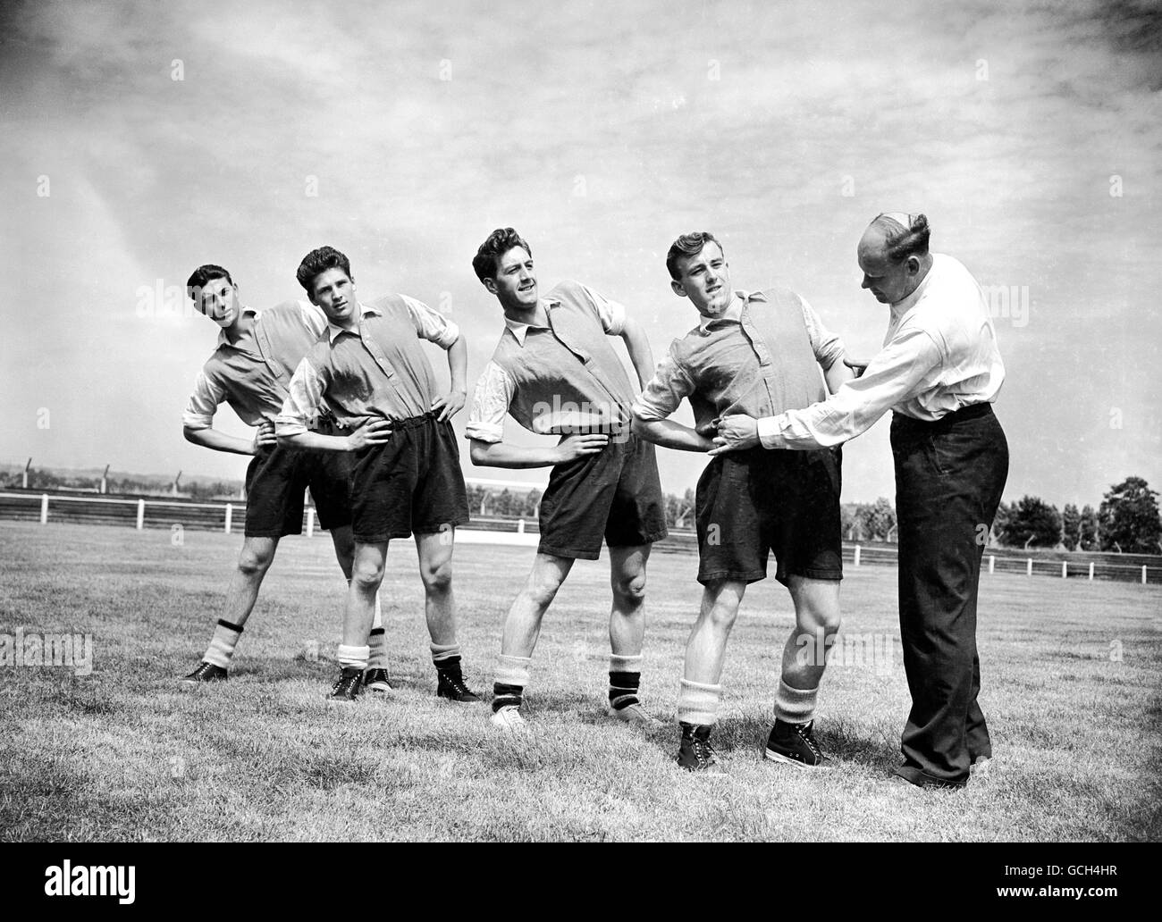 Soccer - League Division One - Arsenal Training - Vale Farm, Hendon. Arsenal coach George Male takes the men through their exercises. Left to right; Jim Fotheringham, Henry Dove, Don Tilley and R. Common Stock Photo