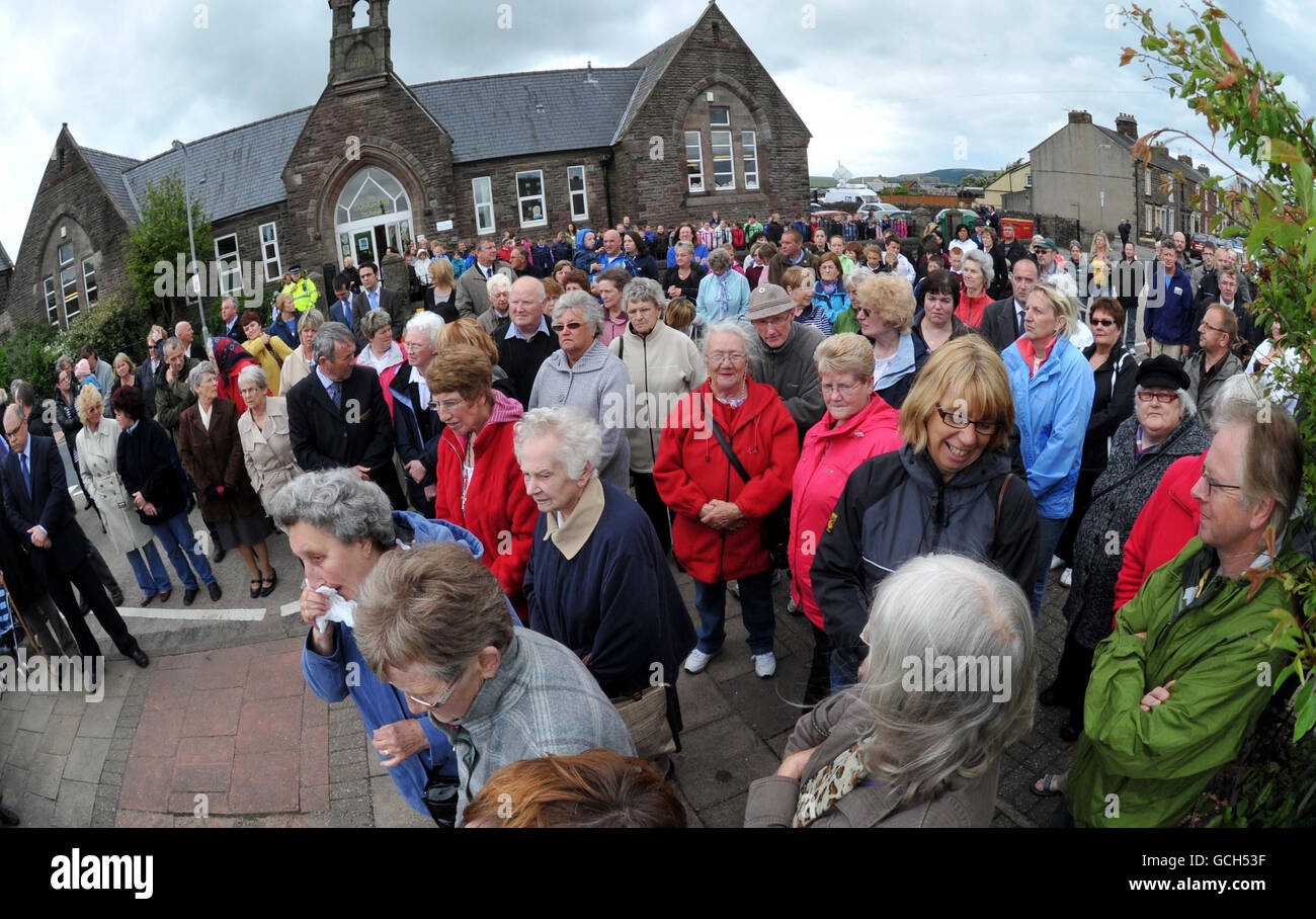 NOTE PICTURE TAKEN WITH AN ULTRA-WIDE ANGLE LENS Members of the public stand during a civic memorial service at Frizington, to commemorate the shooting victims in Cumbria one week on, which left 12 dead, after taxi driver Derrick Bird, 52, drove through the countryside taking potshots at random people. Stock Photo