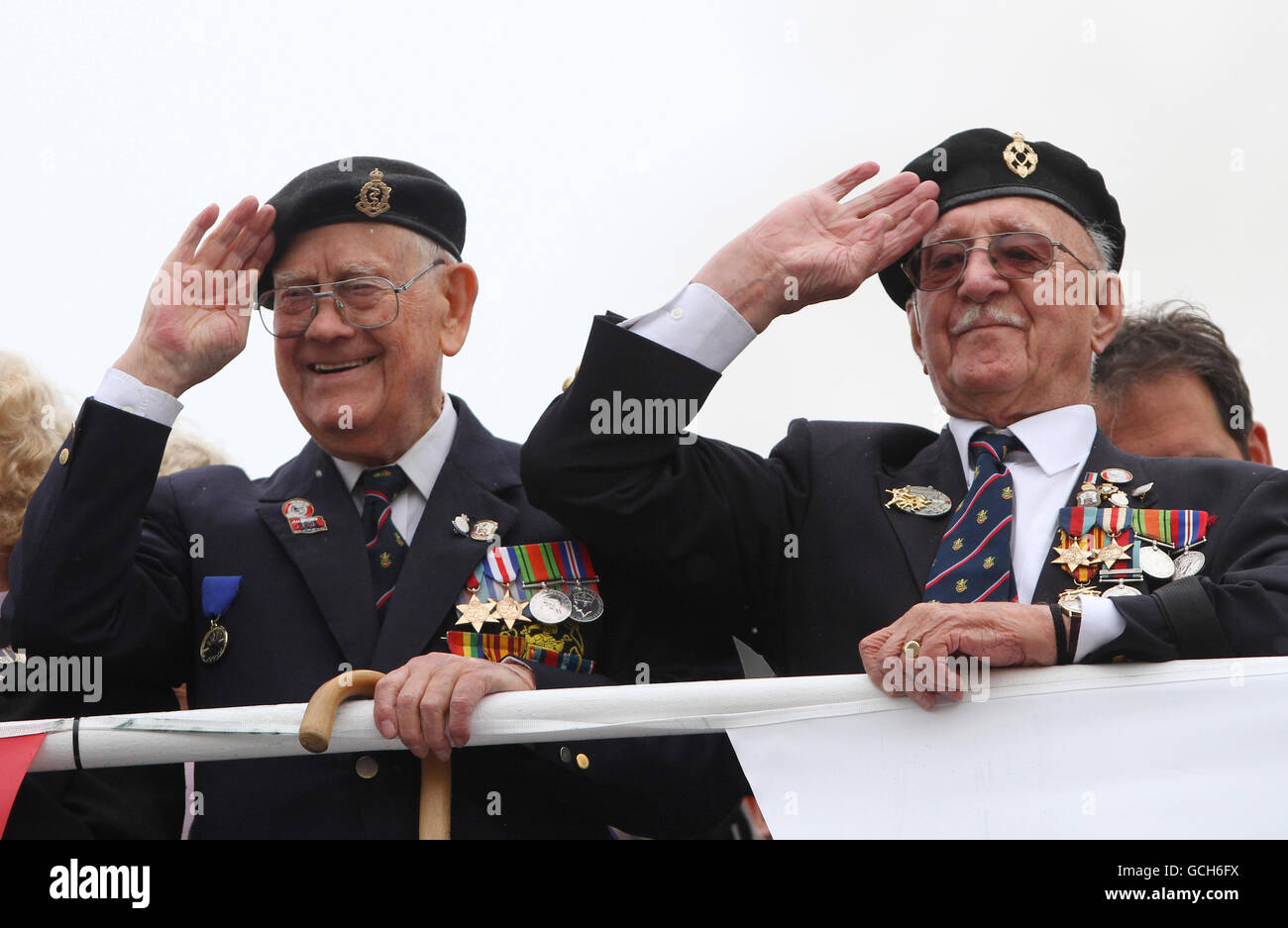 Veterans Charles Searle (left), 92, 3rd Canadian Medical Corps with Lionel Tucker 93, Ox & Bucks Light Infantry salute on board a ferry bound for Dunkirk, France, to commemorate the 70th anniversary of Operation Dynamo. Stock Photo