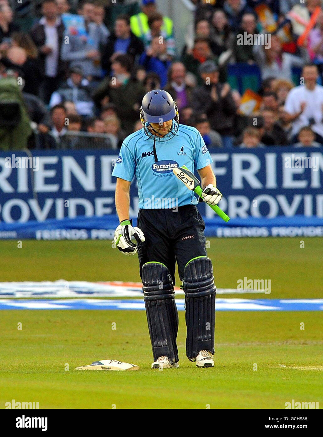 Sussex's Luke Wright picks up the broken piece of his bat after it broke while playing a shot during the Friends Provident T20 match at the County Ground, Hove. Stock Photo