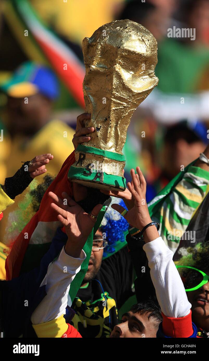 South Africa fans with a model of the World Cup trophy cheers on their side prior to kick off Stock Photo