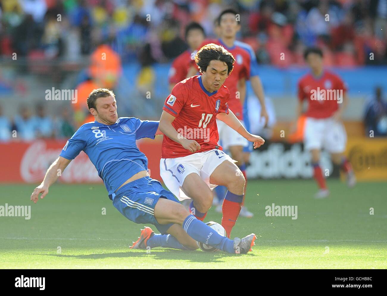South Korea's Chu-Young Park (right) is challenged by Greece's Avraam Papadopoulos (left). Stock Photo