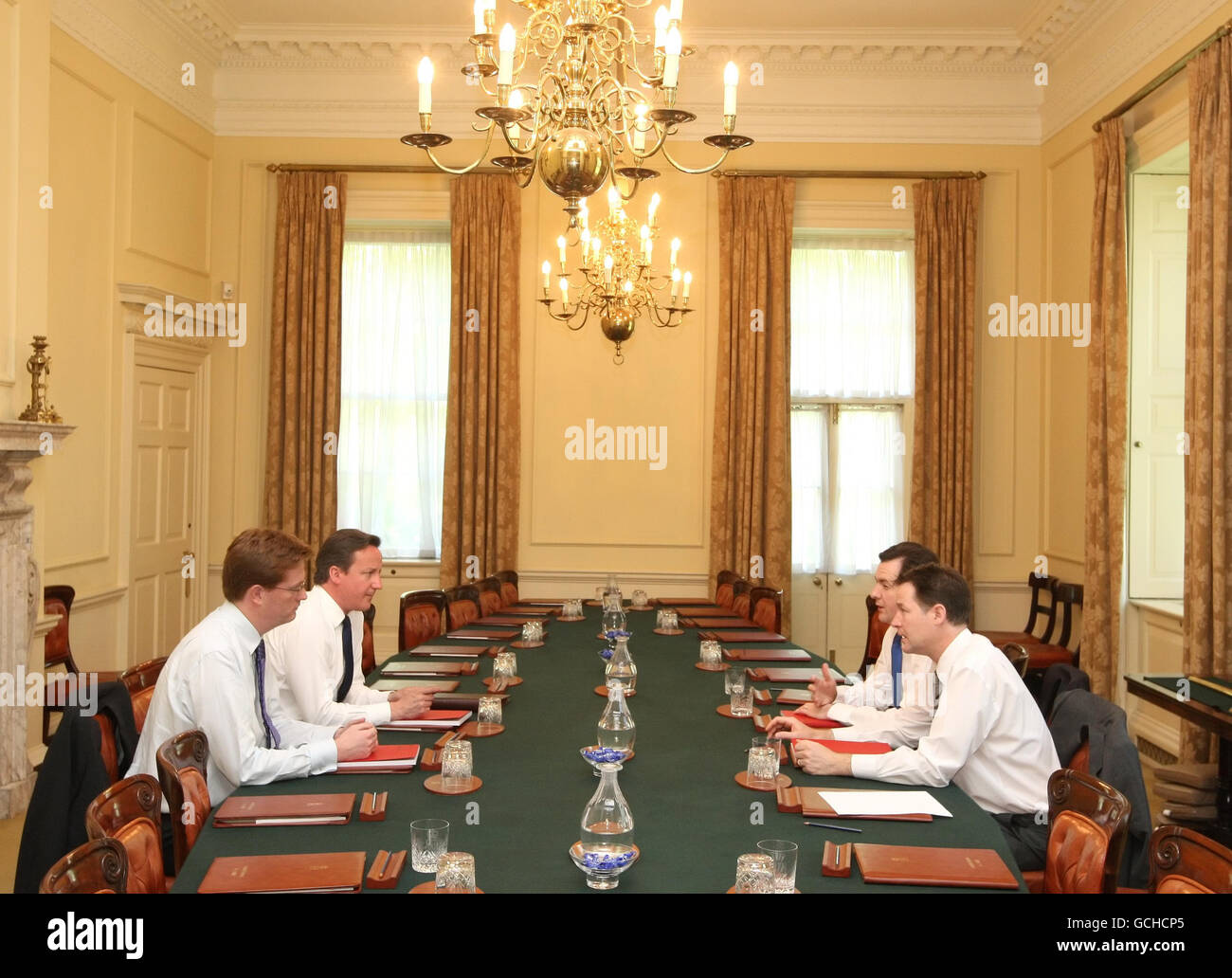 (left to right) Chief Secretary to the Treasury Danny Alexander, Prime Minister David Cameron, Chancellor George Osborne, and Deputy Prime Minister Nick Clegg attend a meeting at 10 Downing Street, Westminster, London, ahead of the coalition government's first budget tomorrow. Stock Photo