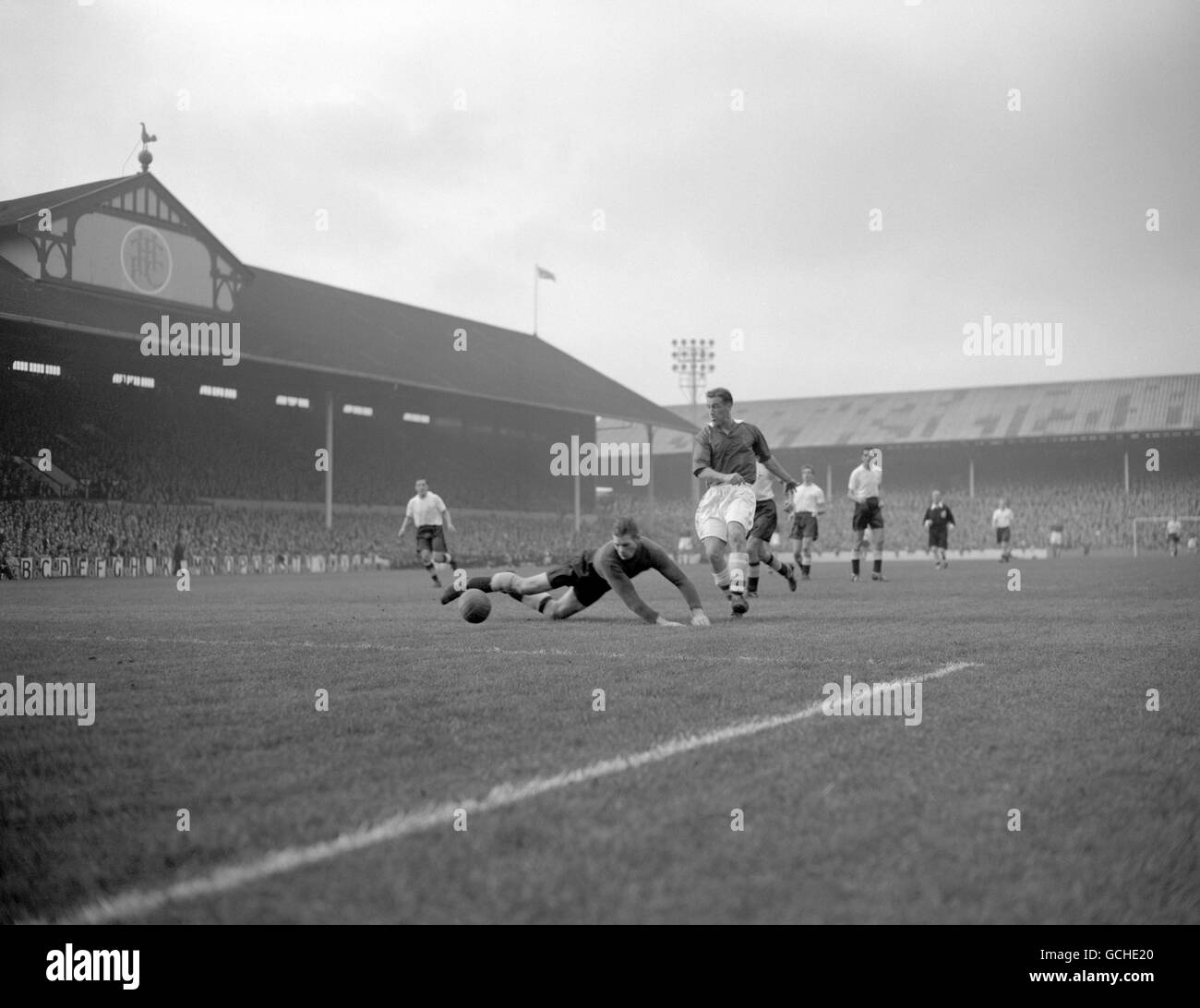 Bolton centre forward Nat Lofthouse follows up to boot the ball past the prostrate Tottenham goalkeeper Ted Ditchburn to give his team the lead. Stock Photo