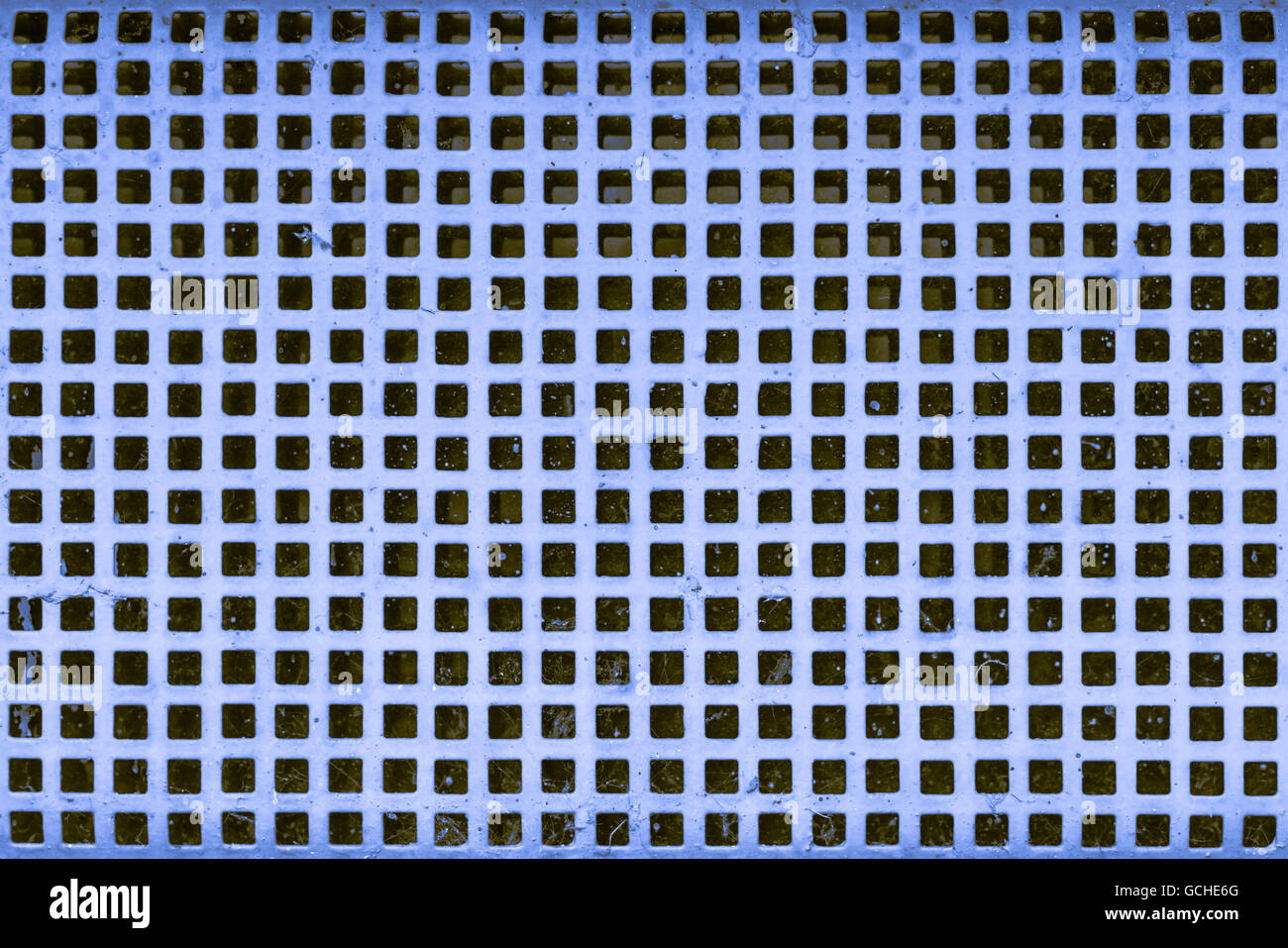 old blue yellowish brownish cellar security grid window with white paint Stock Photo Alamy