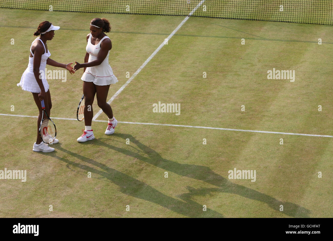 USA's Venus (left) and Serena Williams in their doubles match against Switzerland's Timea Bacsinszky and Italy's Tathiana Garbin during Day Five of the 2010 Wimbledon Championships at the All England Lawn Tennis Club, Wimbledon. Stock Photo