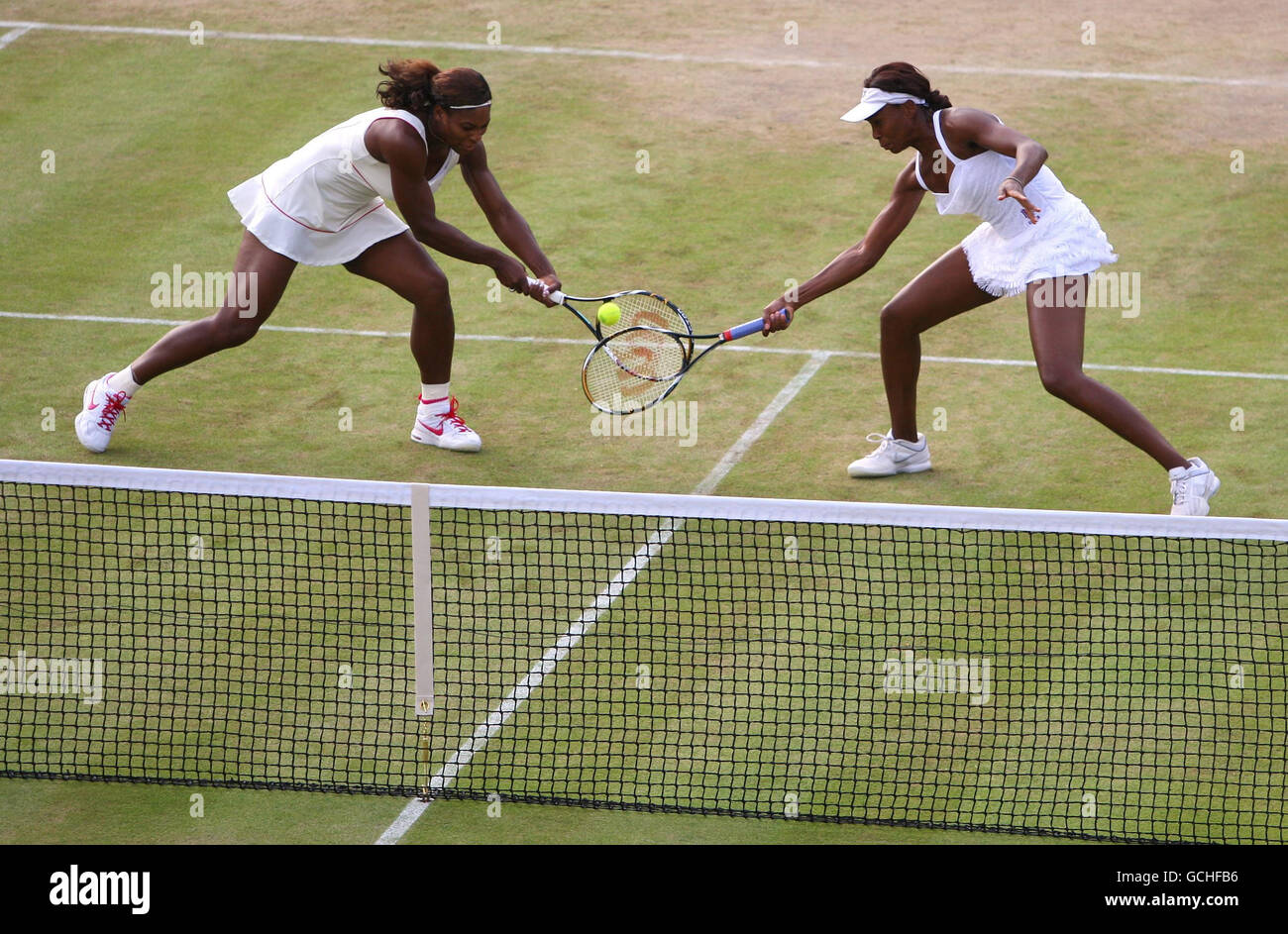 USA's Venus (right) and Serena Williams in their doubles match against Switzerland's Timea Bacsinszky and Italy's Tathiana Garbin during Day Five of the 2010 Wimbledon Championships at the All England Lawn Tennis Club, Wimbledon. Stock Photo