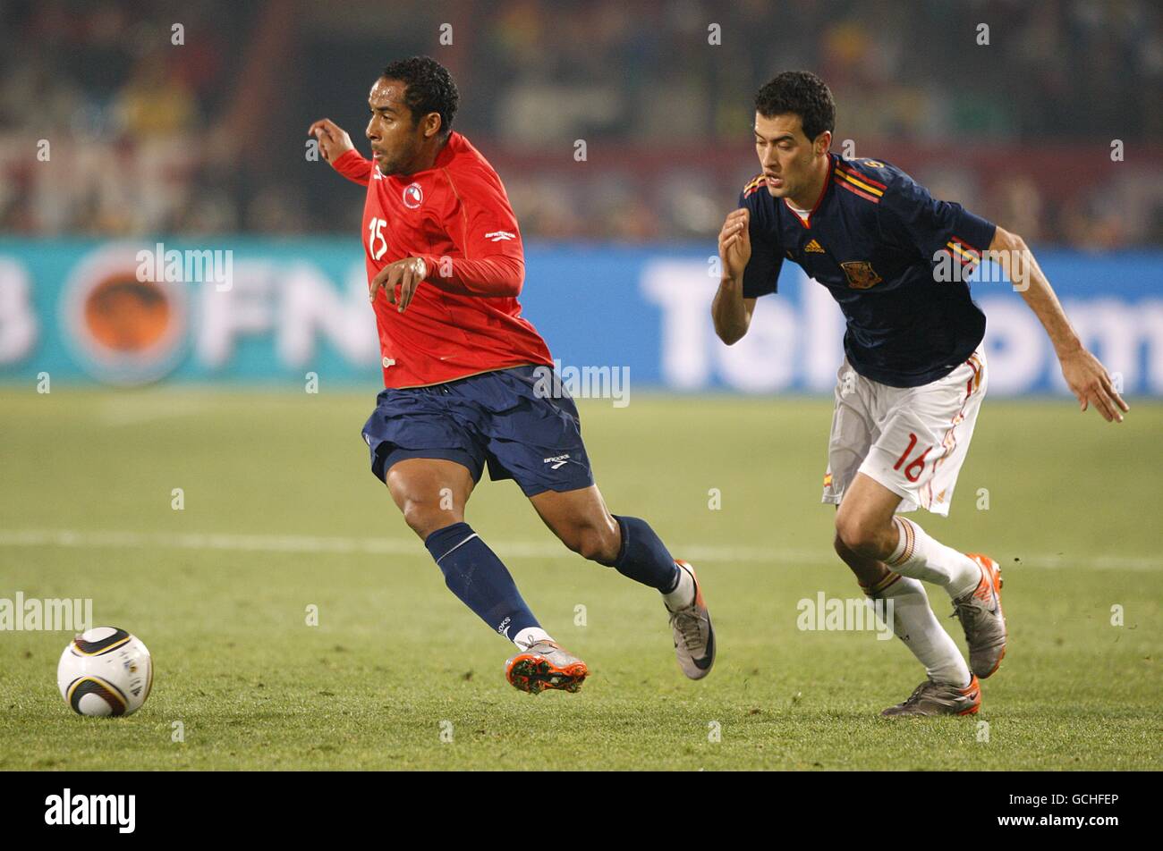 Spain's Sergio Busquets (right) and Chile's Jean Beausejour (left) battle for the ball Stock Photo