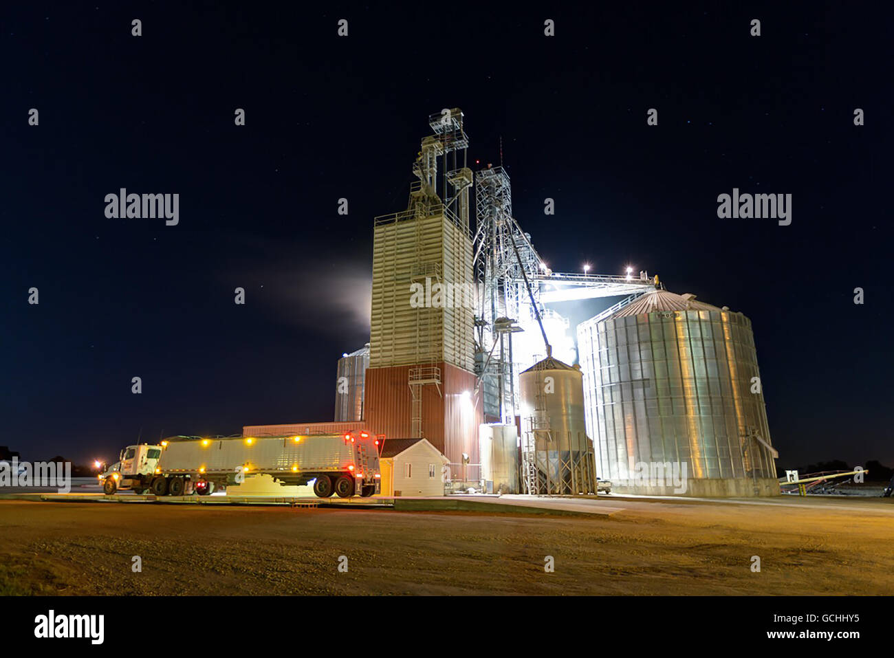 Grain truck parked in front of the Edgewood Feed Mill grain elevator