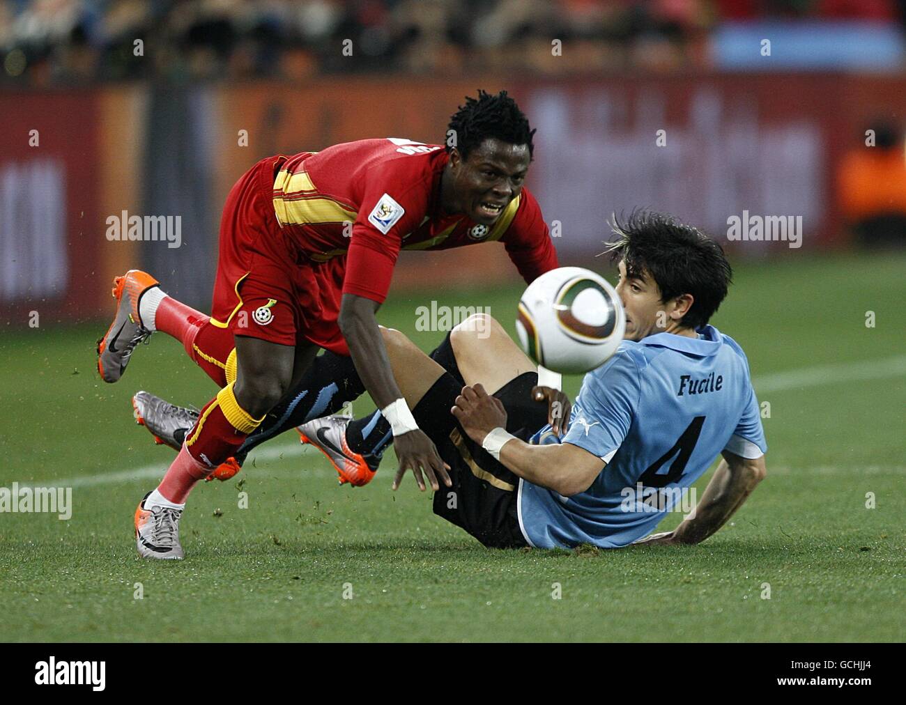 Ghana's Samuel Inkoom (left) and Uruguay's Jorge Fucile battle for the ball Stock Photo