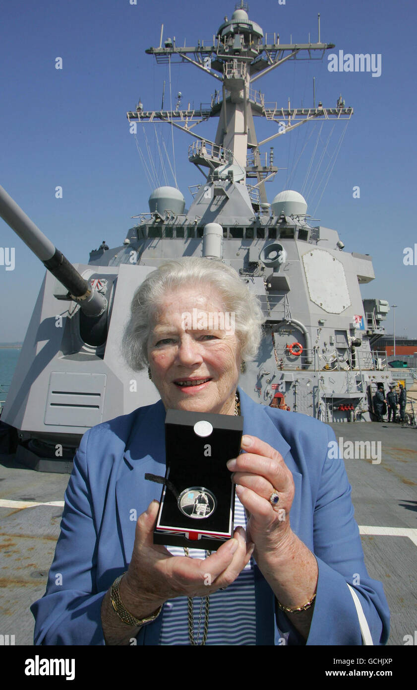 Lady Mary Soames, daughter of Sir Winston Churchill, holds a newly launched 5 coin commemorating her father which was presented to her by the Royal Mint aboard the USS Winston S Churchill which is currently docked in Portsmouth. Stock Photo