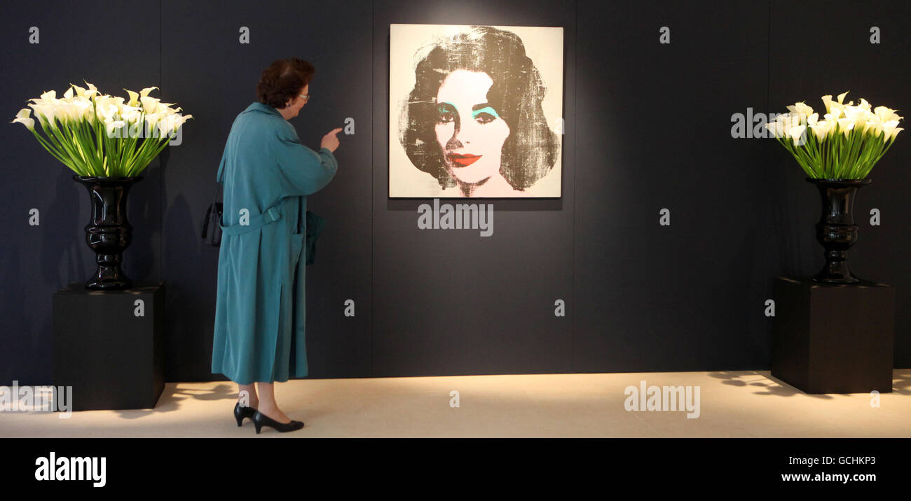A woman views 'Silver Liz, 1963', a rare Andy Warhol portrait of Elizabeth Taylor which has been unseen in public for over 20 years and is estimated to fetch between 6 and 8 million pounds when it goes under the hammer on June 30 as part of Christie's Post War and Contemporary Art Evening auction. Stock Photo