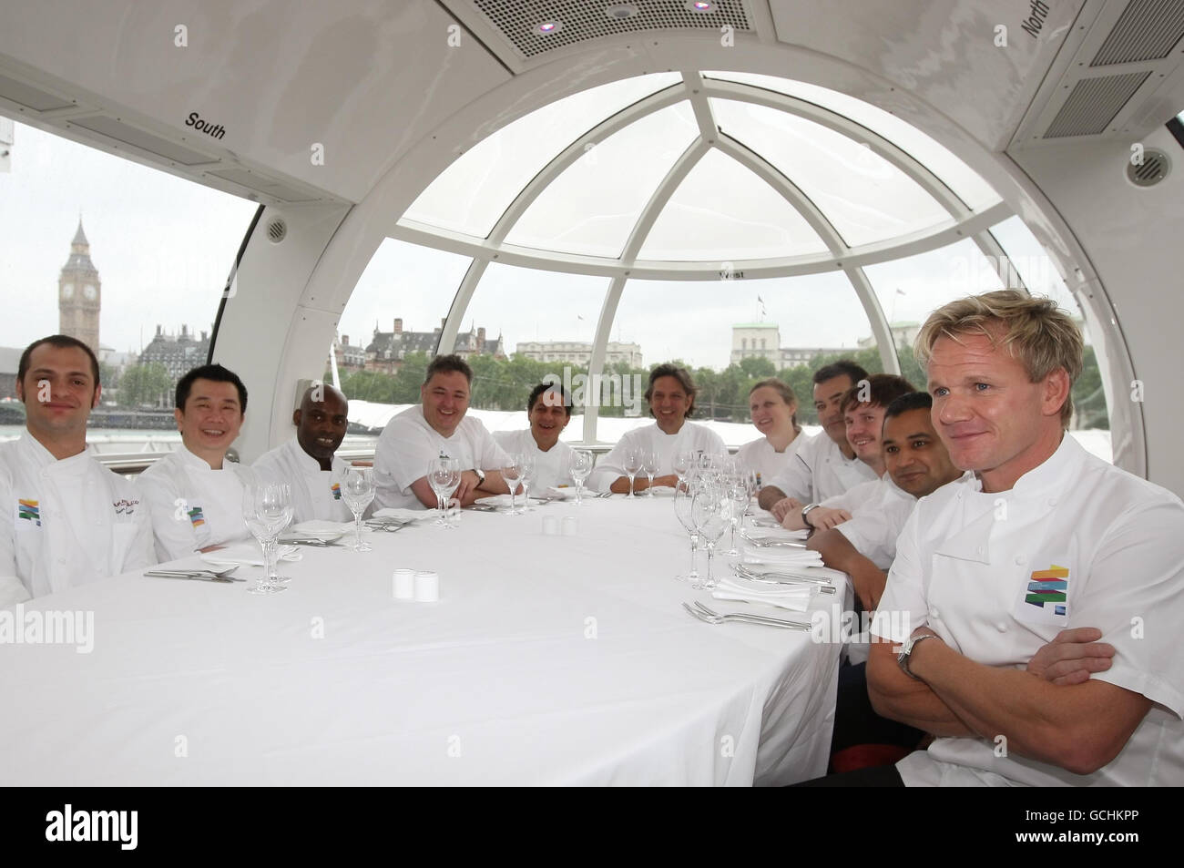 (Left to right) chefs Dean Yasharian, Tong Chee Hwee, Gary Lee, Richard Corrigan, Francesco Mazzei, Georgio Locatelli, Angela Hartnett, Joel Antunes, Kevin Gratton, Jitin Joshi and Gordon Ramsay sit around a dining table in a capsule of the London Eye, which is to be turned into a revolving restaurant for the London Restaurant Festival, which runs from 4 - 18 October 2010. Stock Photo