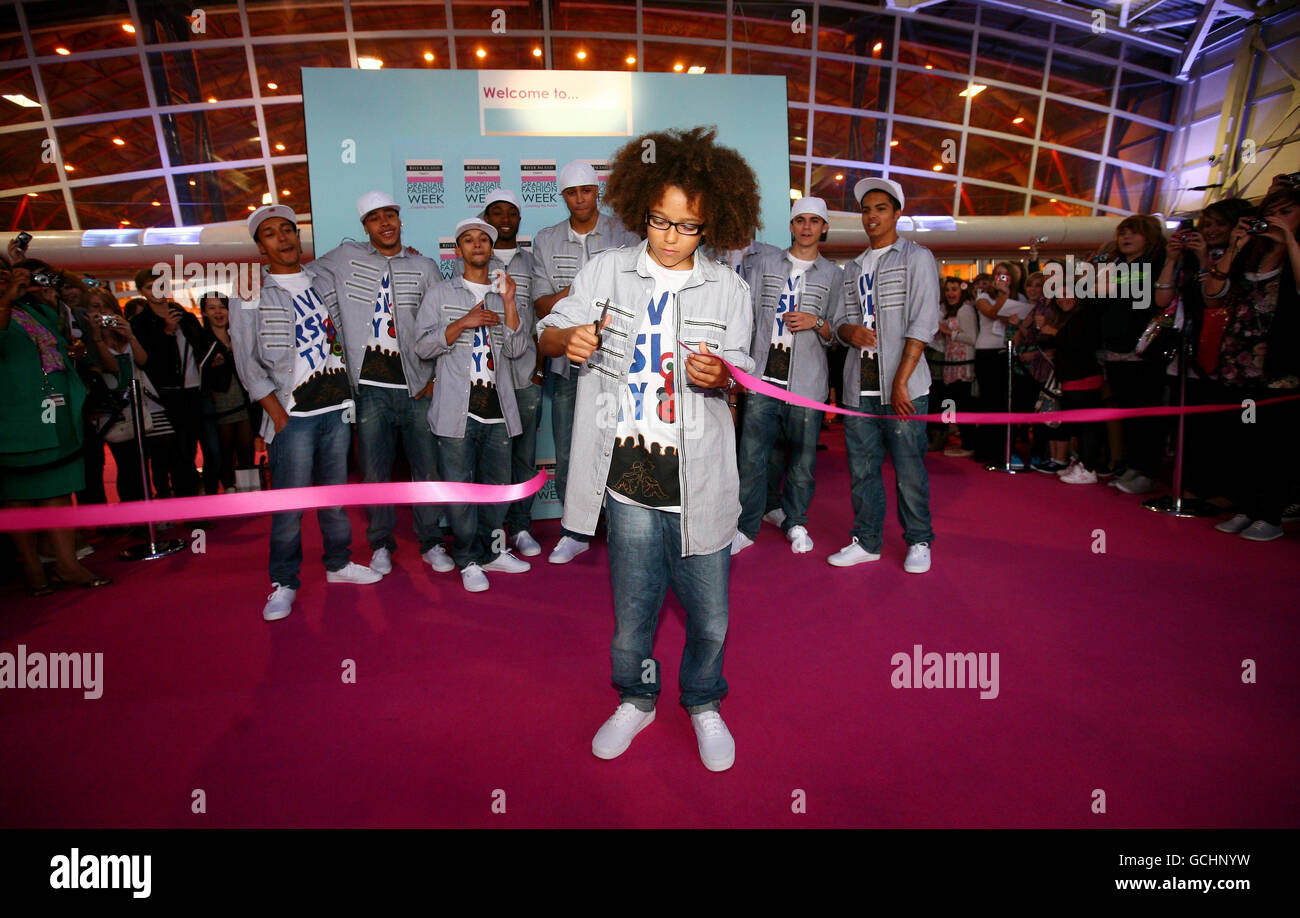 Perri Luc Kiely of dance troupe Diversity cuts a ribbon to open the Graduate Fashion Week Education Day at Earls Court in London. Stock Photo