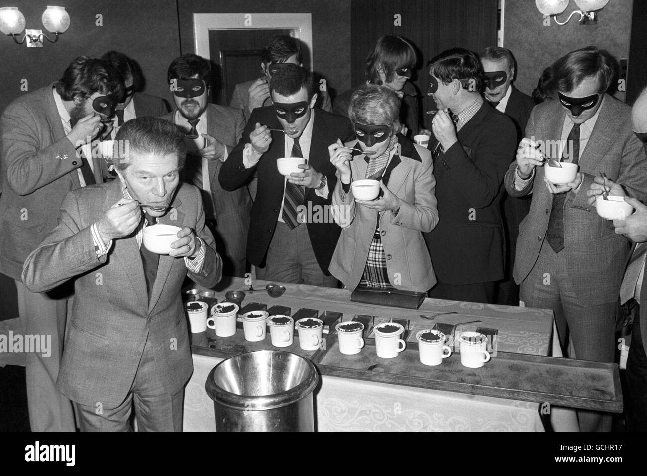 At a hotel in London today, gourmet Egon Ronay (foreground) and his inspectors - masked to elude future recognition - refresh their palates in the art of tea-tasting and blending in a session arranged by the Tea Council. Stock Photo