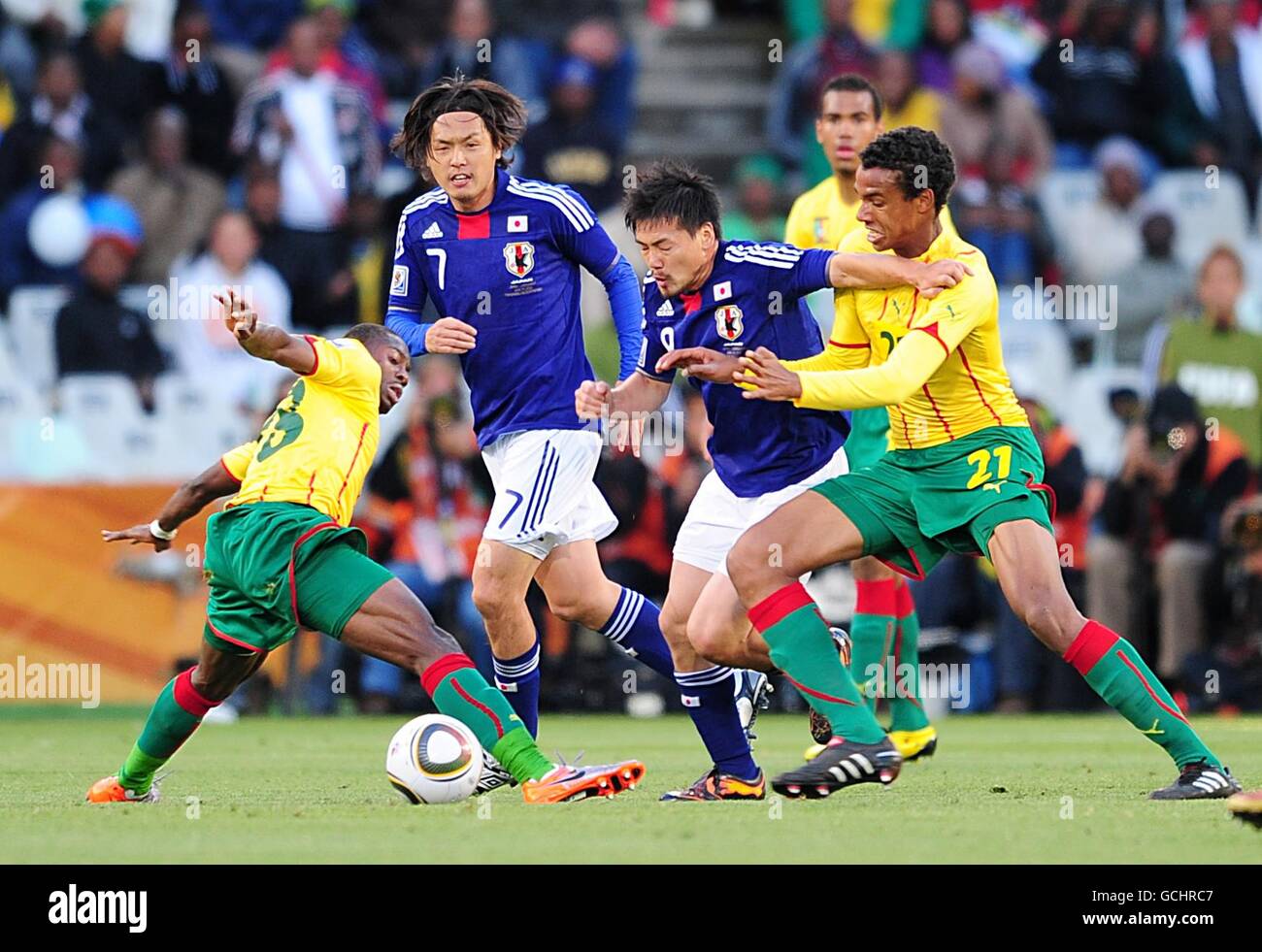 Soccer - 2010 FIFA World Cup South Africa - Group E - Japan v Cameroon - Free State Stadium. Cameroon's Eyong Enoh (left) and Joel Matip (right) in action against Japan's Yuto Nagatomo (centre) Stock Photo