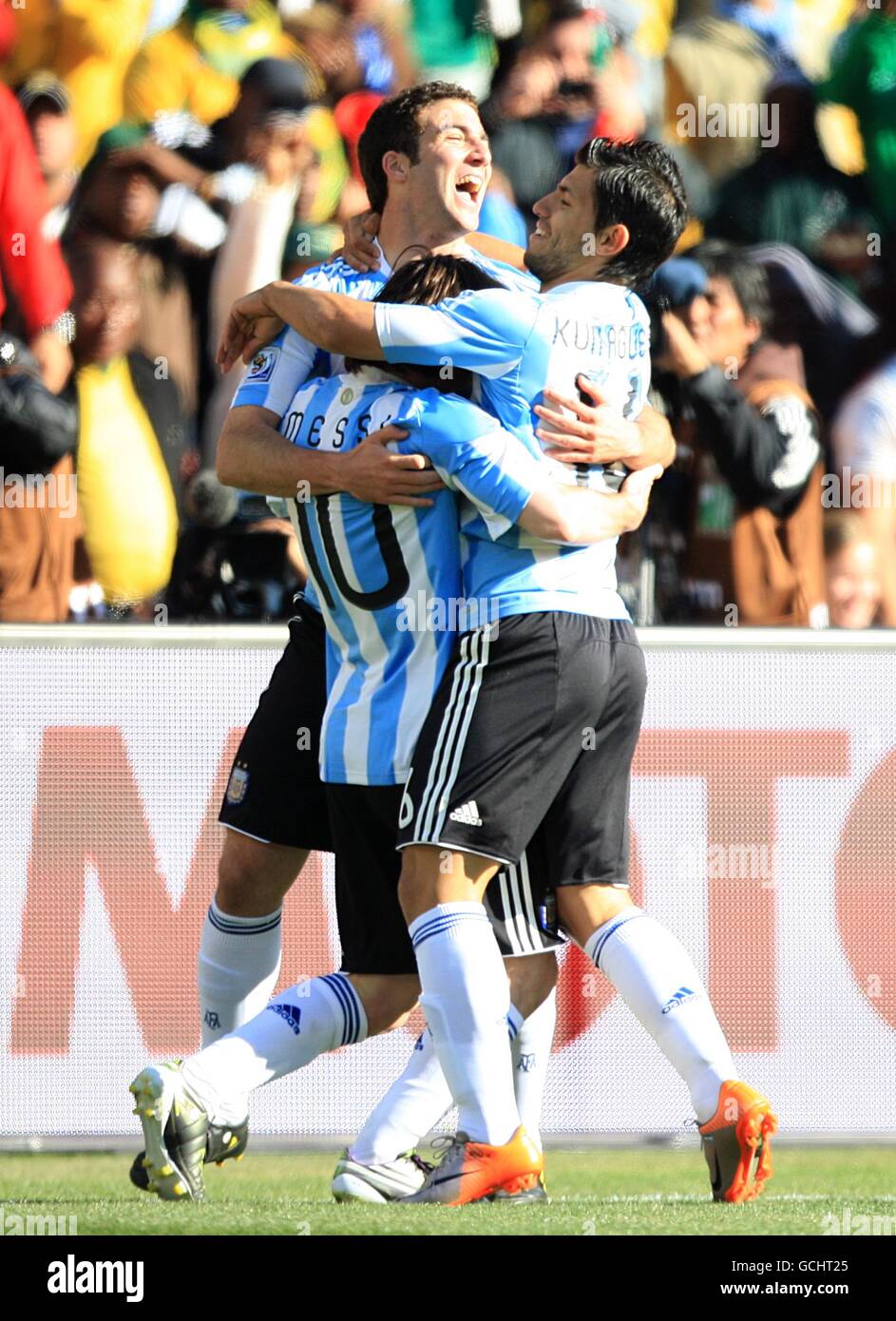 Soccer - 2010 FIFA World Cup South Africa - Group B - Argentina v South Korea - Soccer City Stadium. Argentina's Gonzalo Higuain (centre) celebrates scoring his sides third goal with teammates Sergio Aguero (right) and Leo Messi (left) Stock Photo