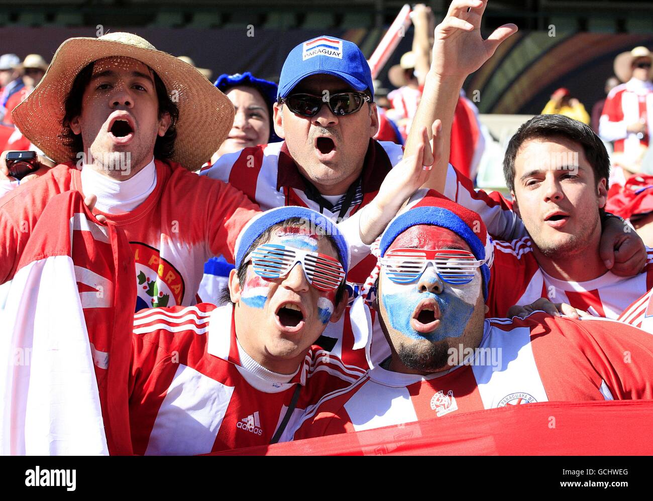 Paraguay fans cheer on their side in the stands hi-res stock