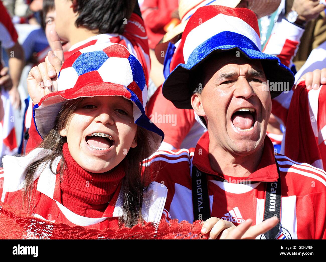 Paraguay fans cheer on their side in the stands hires stock